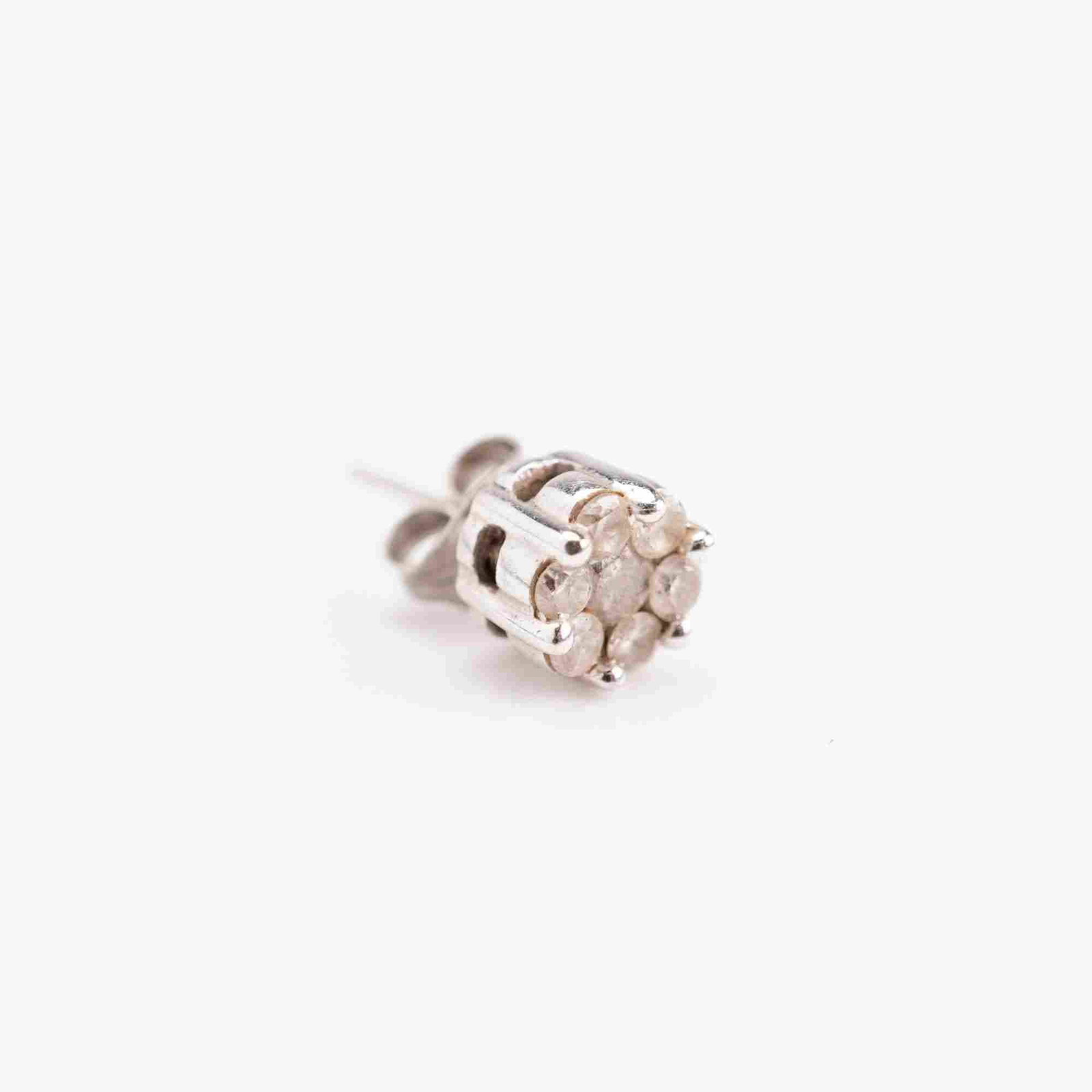 14k White Gold Diamond Cluster Single Stud Earring: This single stud earring is crafted in 14k white gold and features a cluster design. The head of the earring contains seven round-cut diamonds arranged in a circular formation, secured by a multi-pron