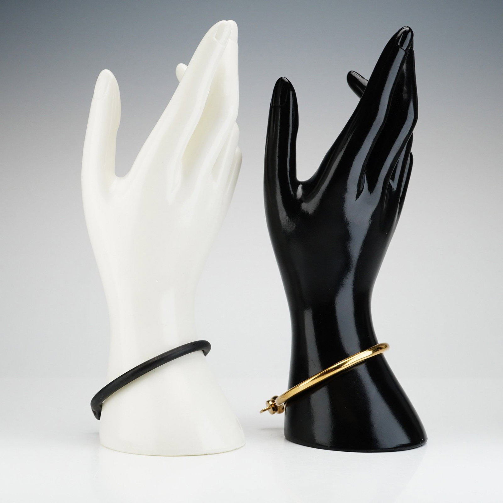 2pc Miansai Noir and Gold-Plated Screw Cuff Bracelets: Two cuff bracelets feature a rounded arc design with a threaded bar closure. Each bracelet is made of stainless steel, with one finished in polished gold plating and the other in black PVD plating. Bo