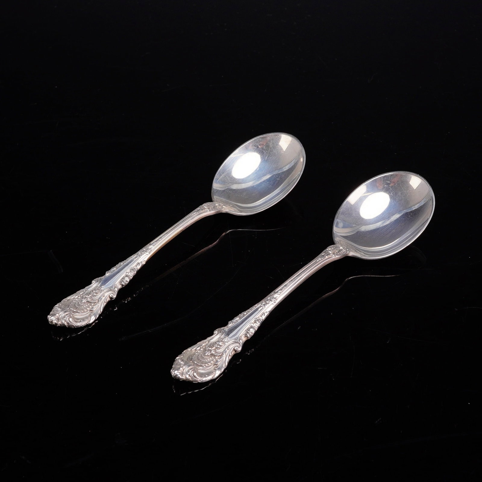 A Pair of Wallace Sterling Silver Soup Spoons in the Sir Christopher Pattern: This pair of solid sterling silver soup spoons is manufactured by Wallace Silversmiths in the Sir Christopher pattern. Introduced in 1936, this pattern features an ornate Renaissance-revival style han