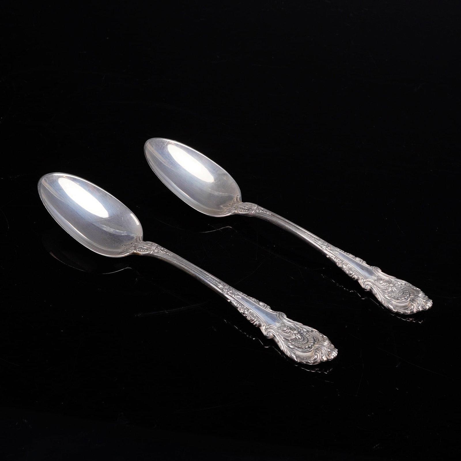 A Pair of Wallace Sterling Silver Teaspoons in the Sir Christopher Pattern: A pair of sterling silver teaspoons manufactured by Wallace Silversmiths in the Sir Christopher pattern. Introduced in 1936 and designed by William S. Warren, this pattern features an ornate Renaissan