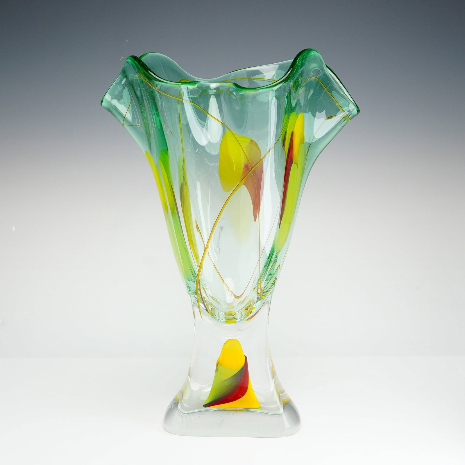 Attributed to Adam Jablonski, Contemporary Hand-Blown Ruffled Art Glass Vase: This contemporary hand-blown studio art glass vase features a tapered body flaring into a wide ruffled handkerchief style rim. The vessel is crafted from clear glass with a light green tint and is dec