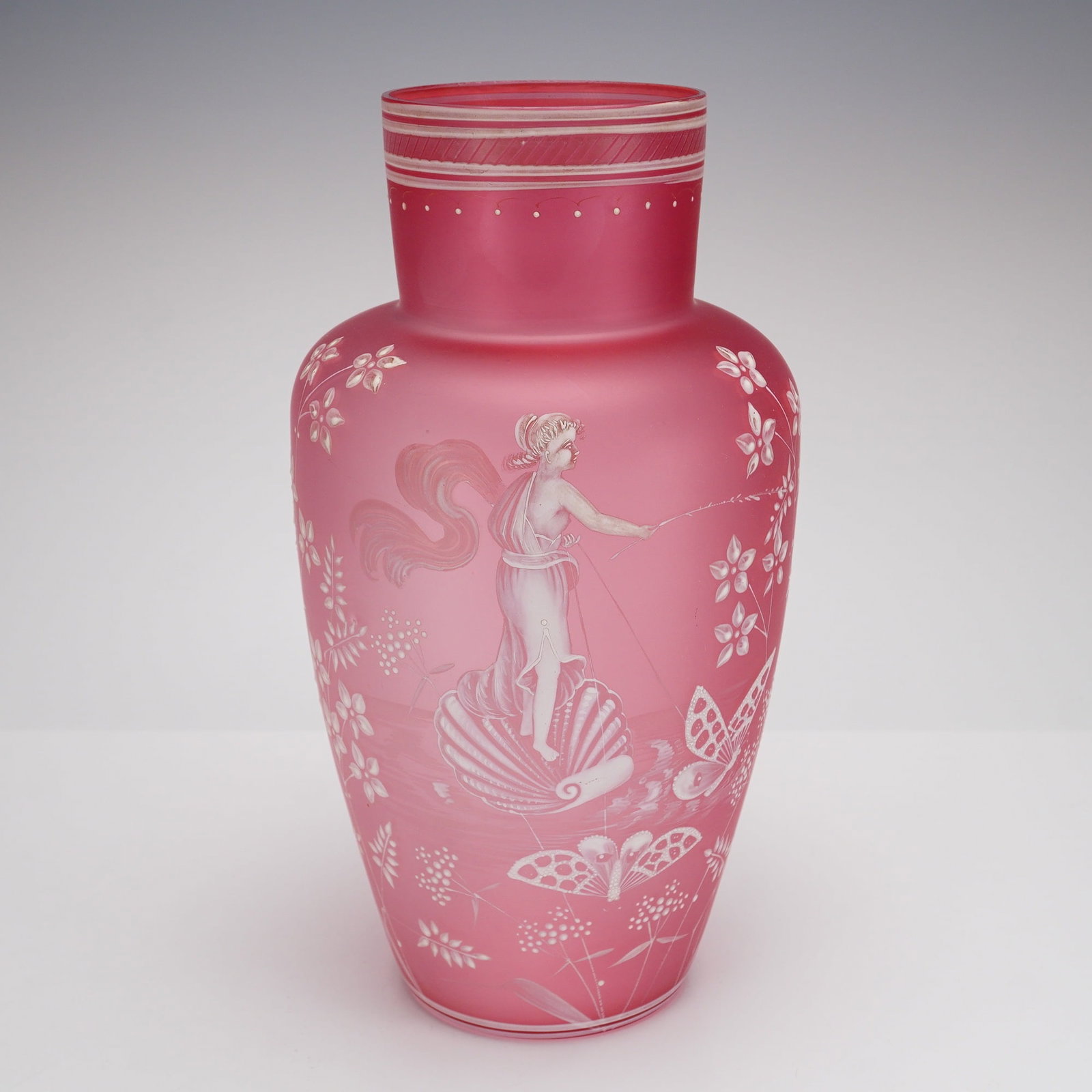 Victorian Hand Painted Blown Glass Transparent Pink Vase: This large, hand blown pink glass vase features a matte satin finish over a lightweight transparent pink body. The central decoration consists of an intricate hand painted white enamel scene in high r