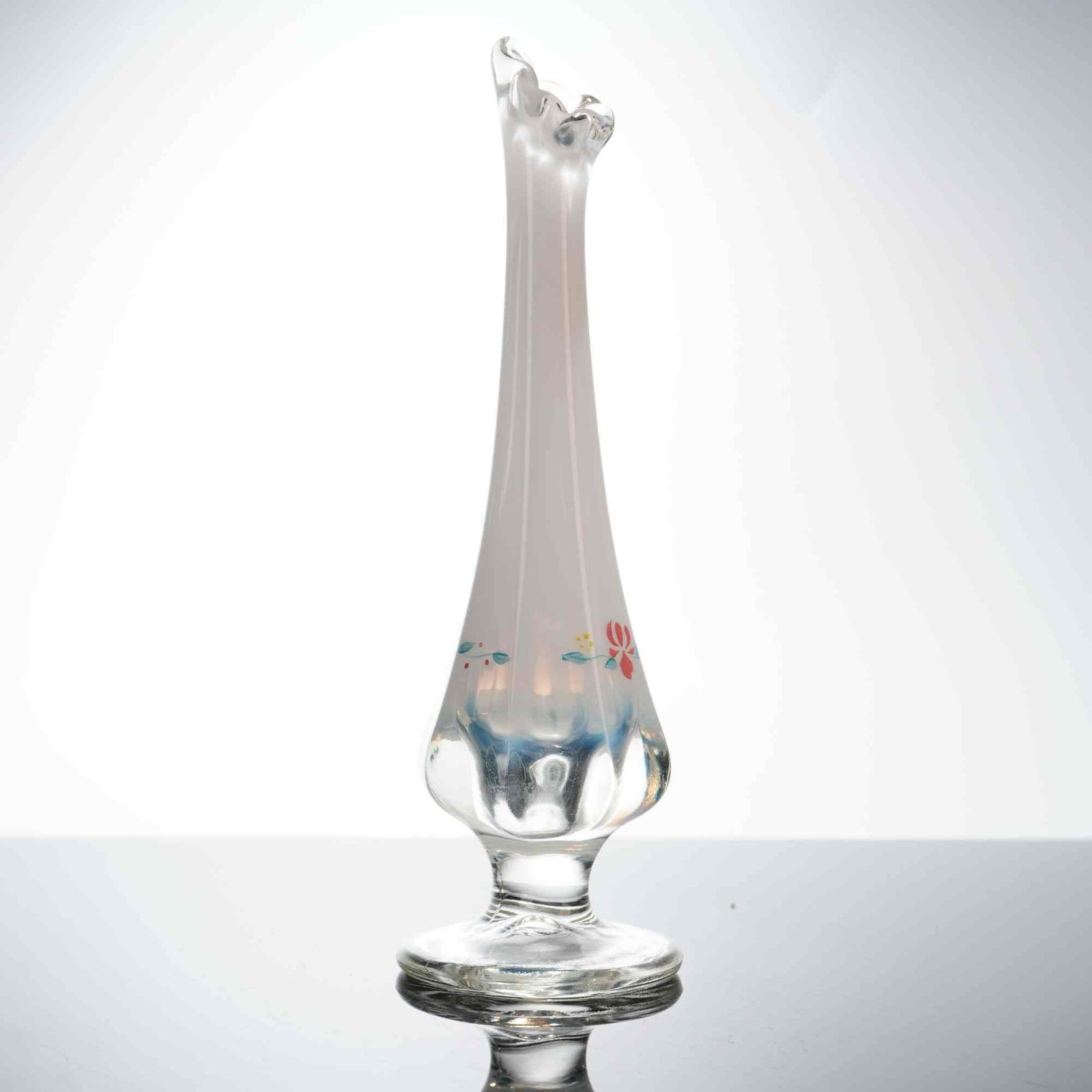 Fenton Hand-Painted Opalescent White and Blue Bud Vase, Country Garden: This Fenton Art Glass bud vase features a tall, slender neck that flares into a ruffled, crimped rim. The body is composed of opalescent white glass that transitions into a clear, bulbous base with a 