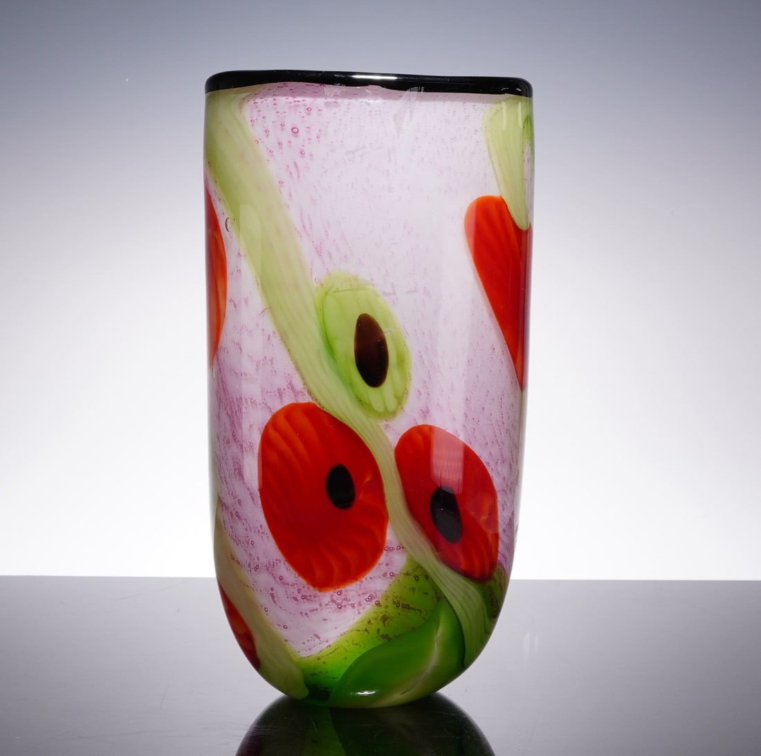 Murano Style Poppy Motif Art Glass Vase: This hand-blown art glass vase features a vibrant red poppies motif. The vessel is crafted in a tall, cylindrical form with a softly tapered, rounded base and a flat, polished rim. The construction ut