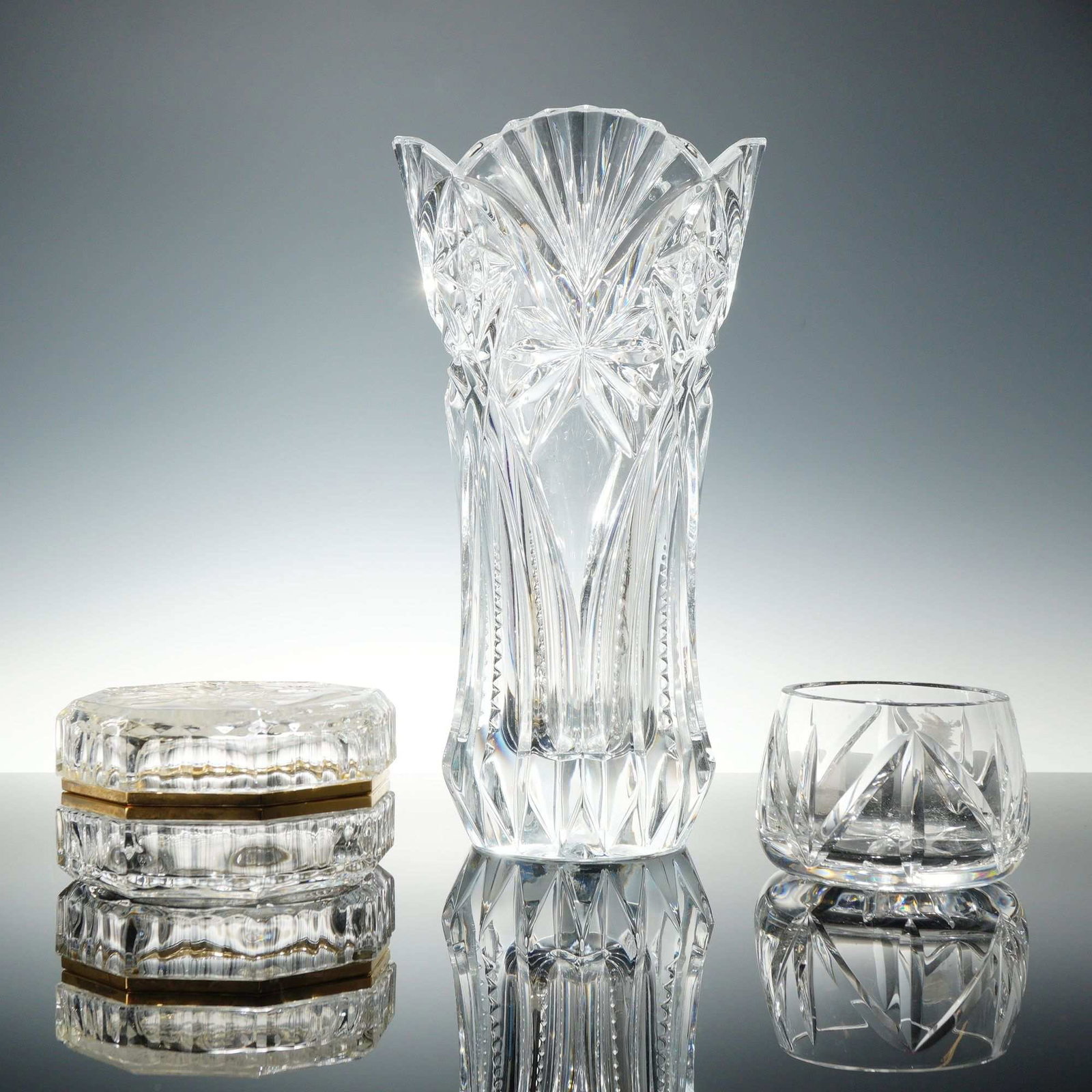 3pc Vintage Lead Crystal Set Including Mikasa: Features a trio of lead crystal decorative vase, lidded box and small bowl . This curated collection features a mix of cut-crystal patterns that brilliantly refract light. Measurement for the tallest.