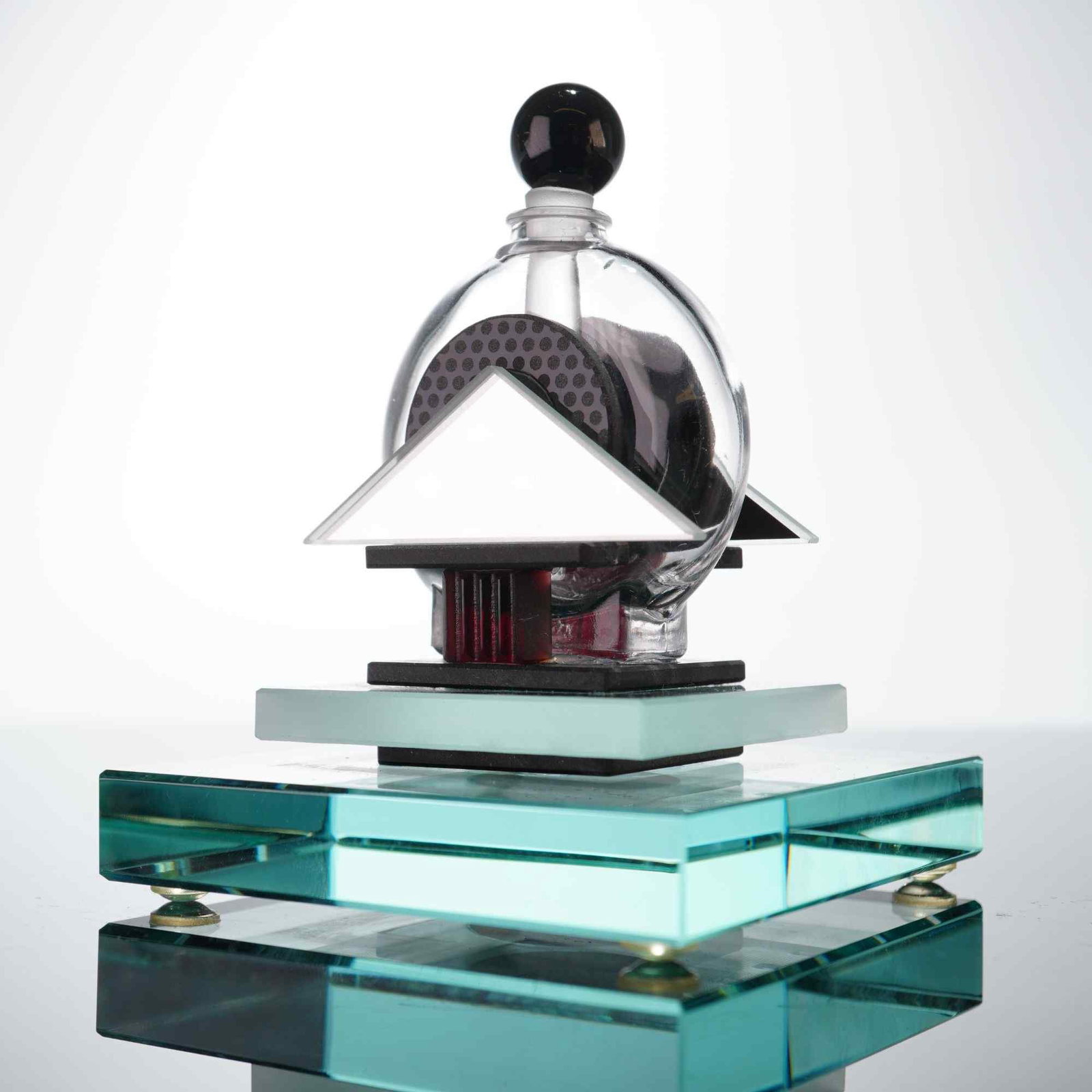 George Ponzini Neo-Deco Studio Art Glass Perfume Bottle: This contemporary studio art glass perfume bottle is the work of American artist George Ponzini (b. 1952). The piece features a complex postmodern architectural design constructed from multiple geomet