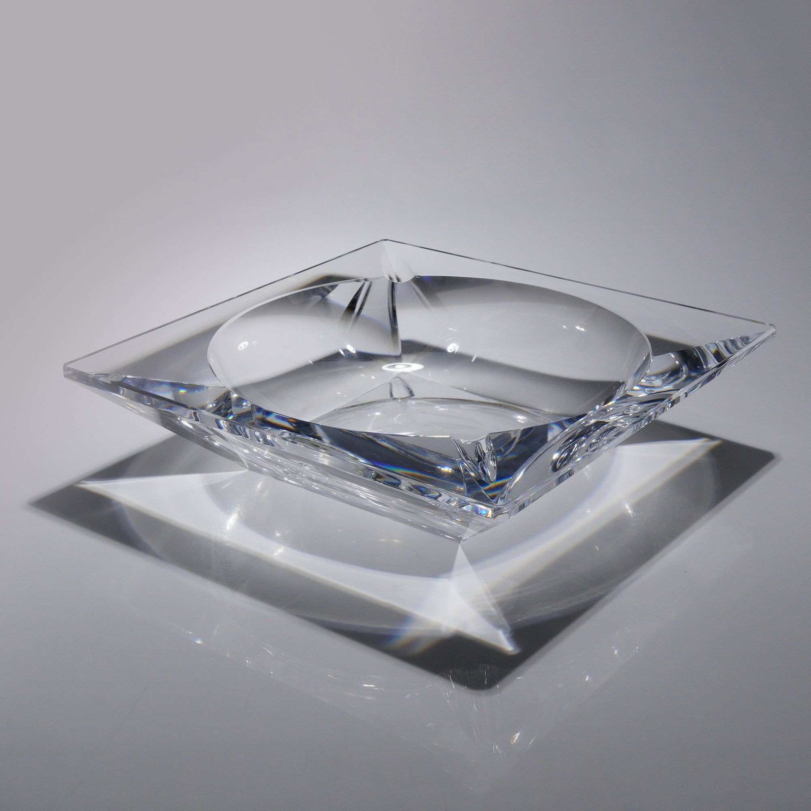 Val Saint Lambert Heavy Lead Crystal Square Cigar Ashtray: A substantial clear lead crystal ashtray manufactured by Val Saint Lambert in Belgium. This modernist piece is designed as a thick-walled square block with deep beveled edges. It features a polished c