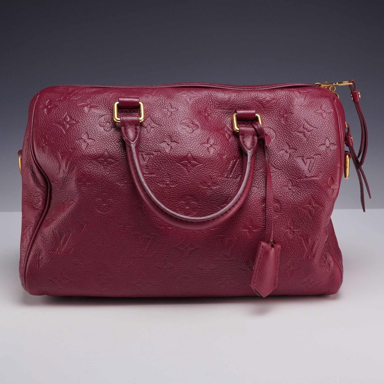 Louis Vuitton Speedy Bandouliere 25 Monogram Empreinte in Aurore: This Louis Vuitton Speedy Bandouliere 25 is crafted from Aurore-colored Monogram Empreinte leather, featuring the house motif deeply embossed into calfskin leather. This bag has been Entrupy authentic