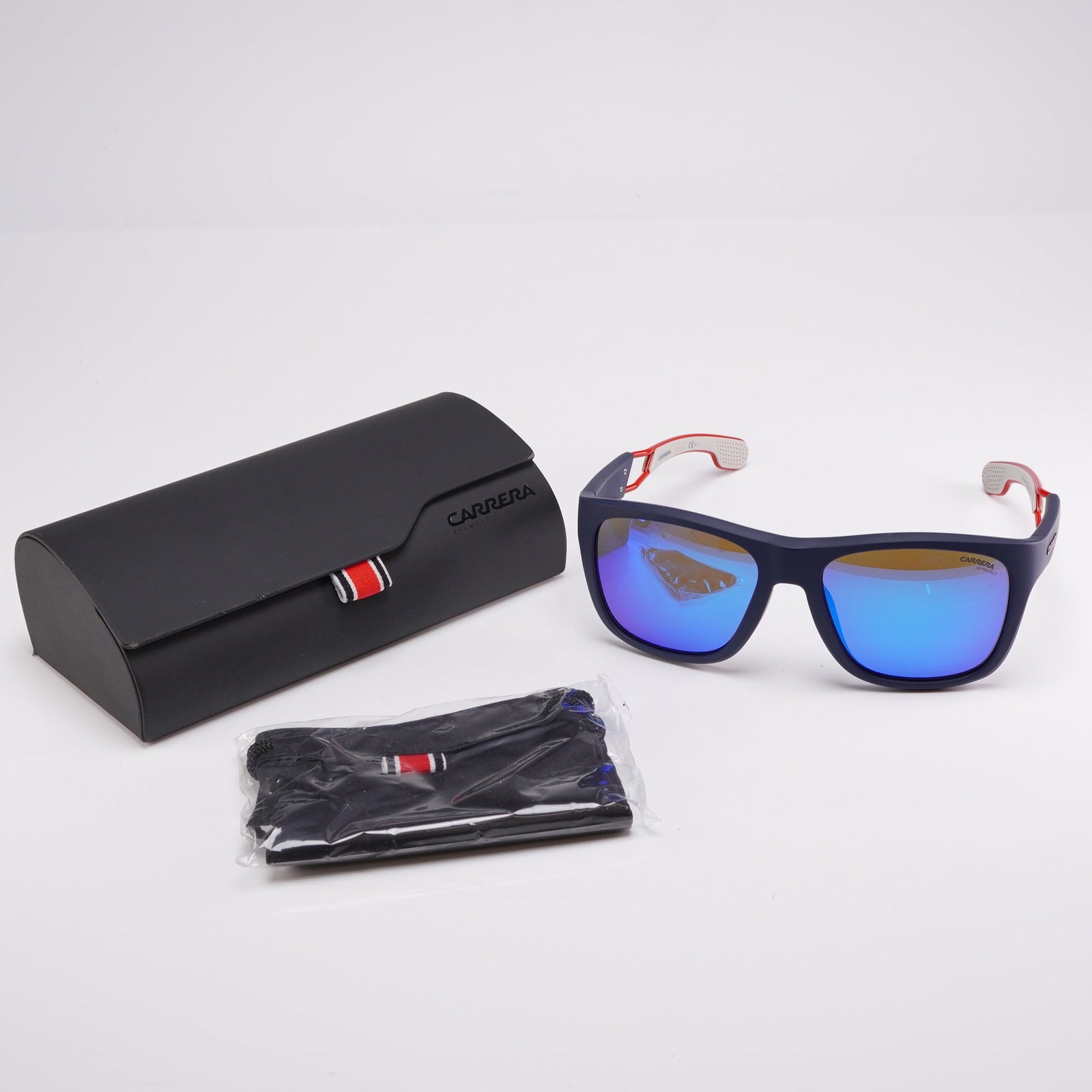 Carrera 4007/S RCTZ0 Sunglasses with Original Case: A pair of Carrera model 4007/S RCTZ0 sunglasses featuring a rectangular frame design. The frames are constructed from matte navy blue plastic. The temples are designed with a distinctive open-work red