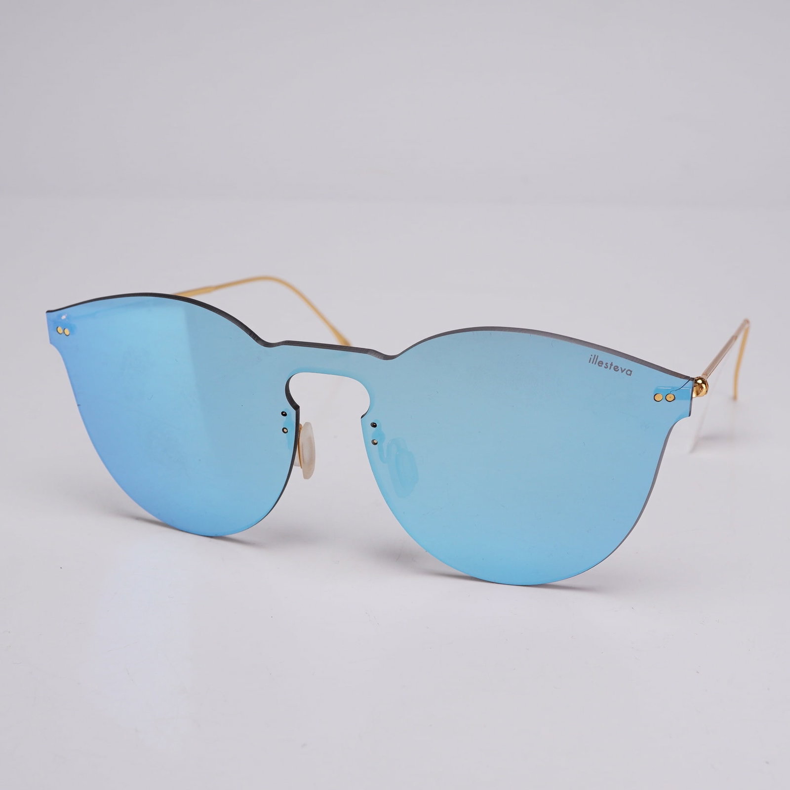 Illesteva Women's Leonard II Square Mask Sunglasses in Sky Blue: Illesteva Women's Leonard II square sunglasses featuring a rimless shield-style mask design. The construction consists of a single-piece synthetic lens with a Sky Blue mirrored finish on the exterior 