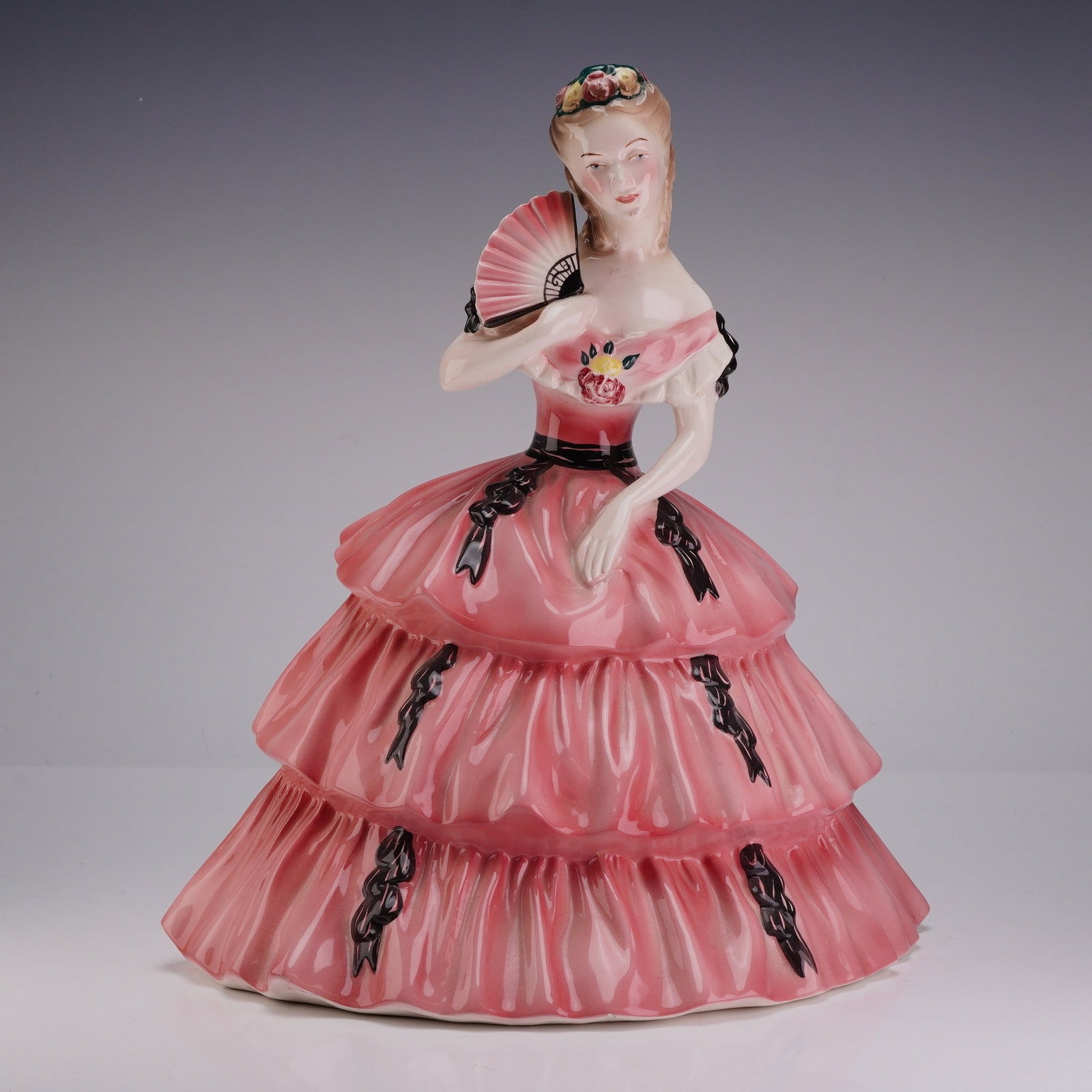 Goldscheider Everlast USA Fine China Figurine by P. Porcher, Southern Belle: A mid-20th-century American glazed ceramic figurine produced by Goldscheider Everlast Corp. The figure, identified as a Southern Belle, is depicted in a three-tiered pink crinoline gown decorated with
