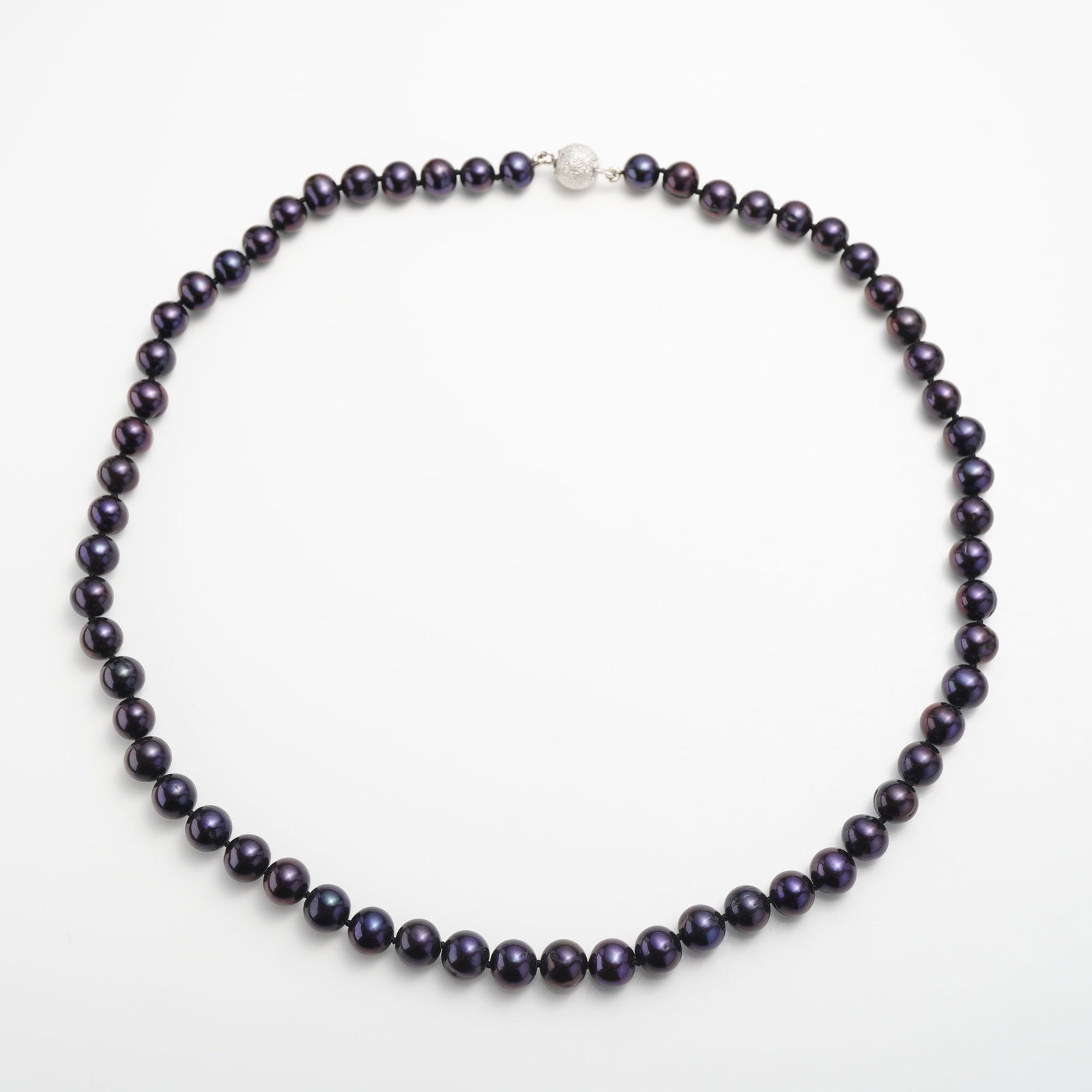 Cultured Black Freshwater Pearl Necklace with Orb Clasp: A single-strand necklace composed of perfectly round cultured freshwater pearls. The pearls exhibit a dark body color with luminous iridescent overtones of deep purple. The strand is individually knot