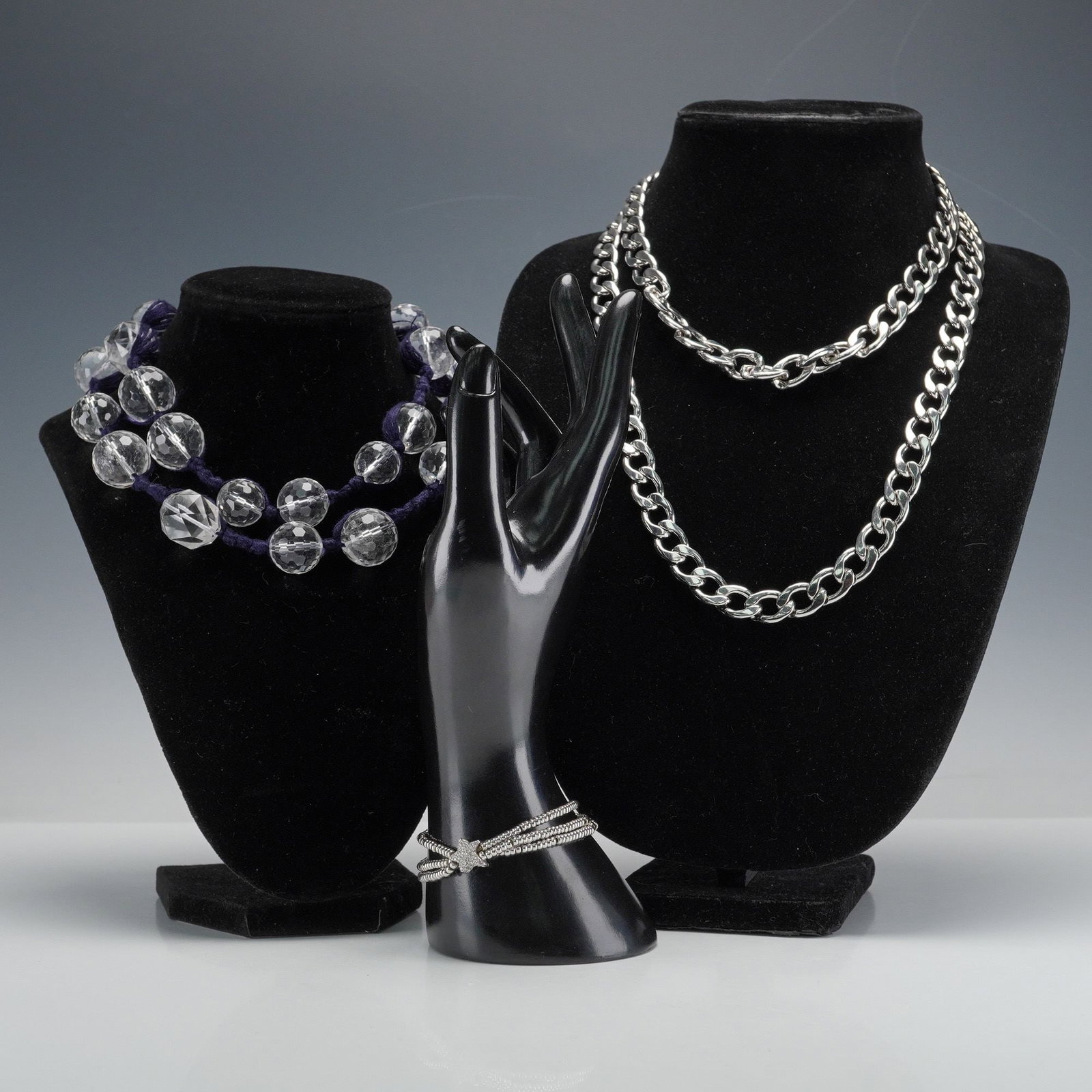 3pc Miami Cuban Link Chain, Faceted Glass Necklace & Star Bracelet: A group of three pieces of costume jewelry comprising a two-strand silver-tone metal chunky link chain necklace with a Miami Cuban link. Also included is a two-strand necklace featuring large, faceted