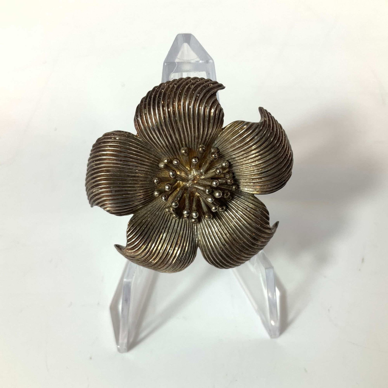 Tiffany and Co. Sterling Silver Dogwood Flower Brooch: A Tiffany and Co. sterling silver brooch in the Dogwood pattern. The design features a stylized five-petal floral motif where each petal displays a fine, radial ribbed texture extending from the cente