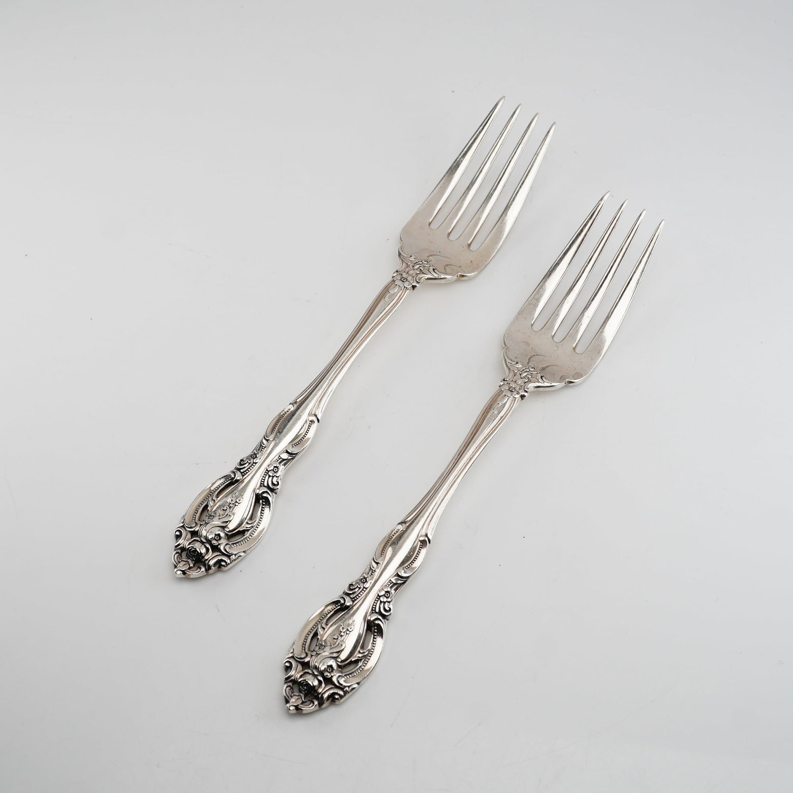 2pc Gorham Sterling Silver Salad Forks, La Scala: This Rococo-revival design is characterized by ornate scrolling borders, shell-like flourishes at the shoulders, and elaborate floral and foliate motifs at the terminal. The handles feature deep, high