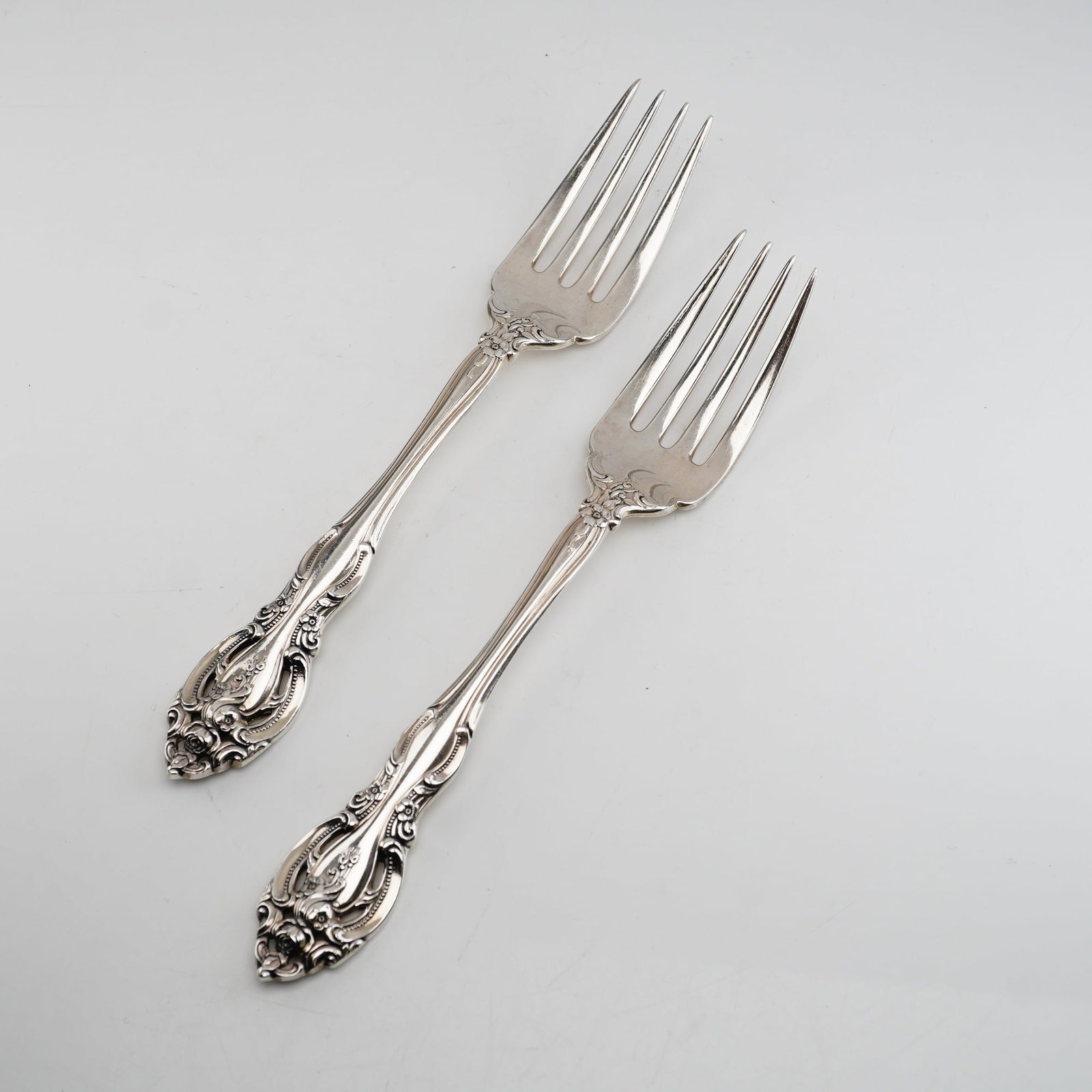 2pc Gorham Sterling Silver Salad Forks, La Scala: Characterized by its Rococo Revival style, featuring scrolled borders, acanthus leaf accents, and floral sprays at the handle terminal and shoulder. Each fork is crafted from solid .925 sterling silve