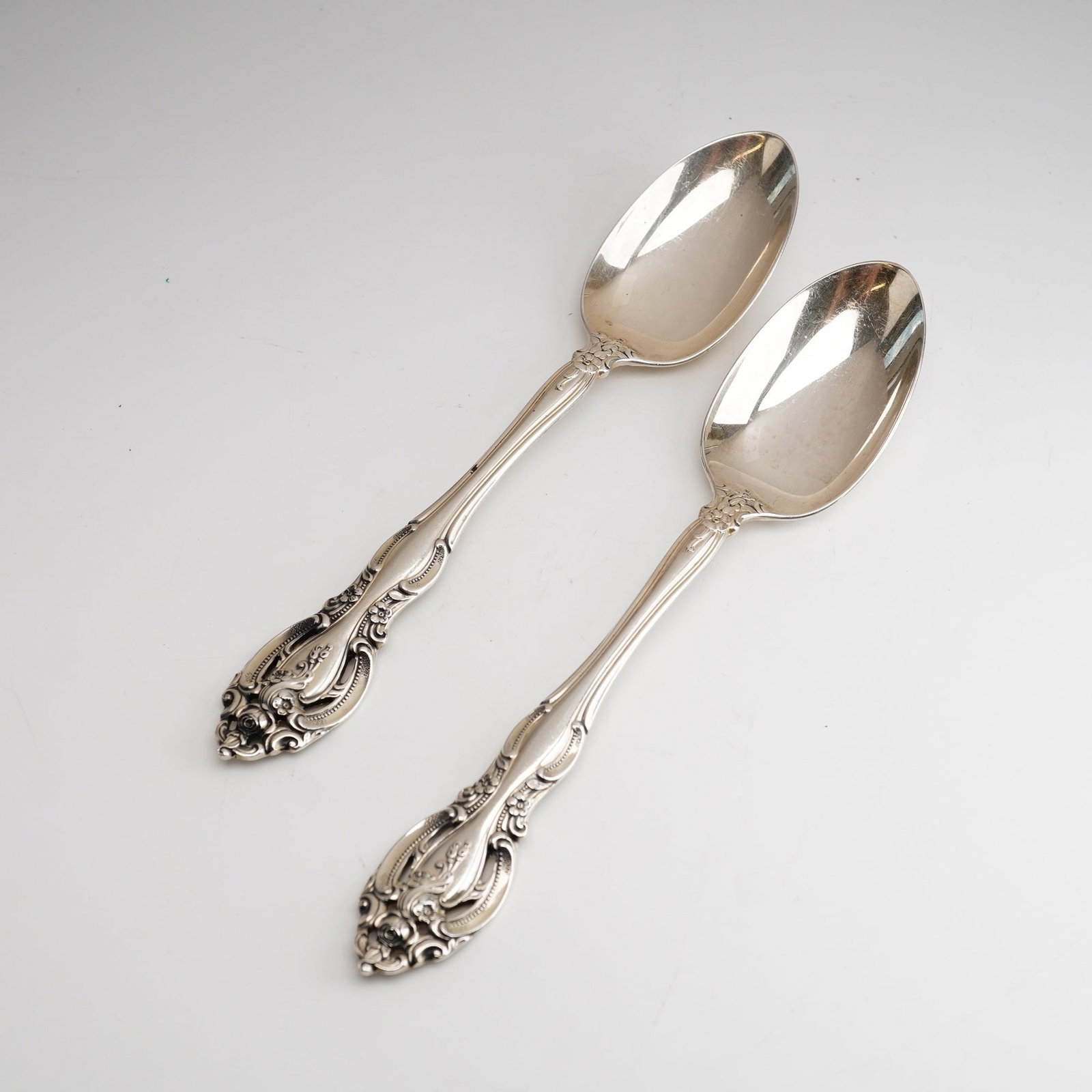 2pc Gorham Sterling Silver Teaspoon, La Scala: Featuring elaborate scrollwork, shell motifs, and a central rose at the tip of the handle terminal. This pair of sterling silver flatware features a script engraving on the reverse of each handle term