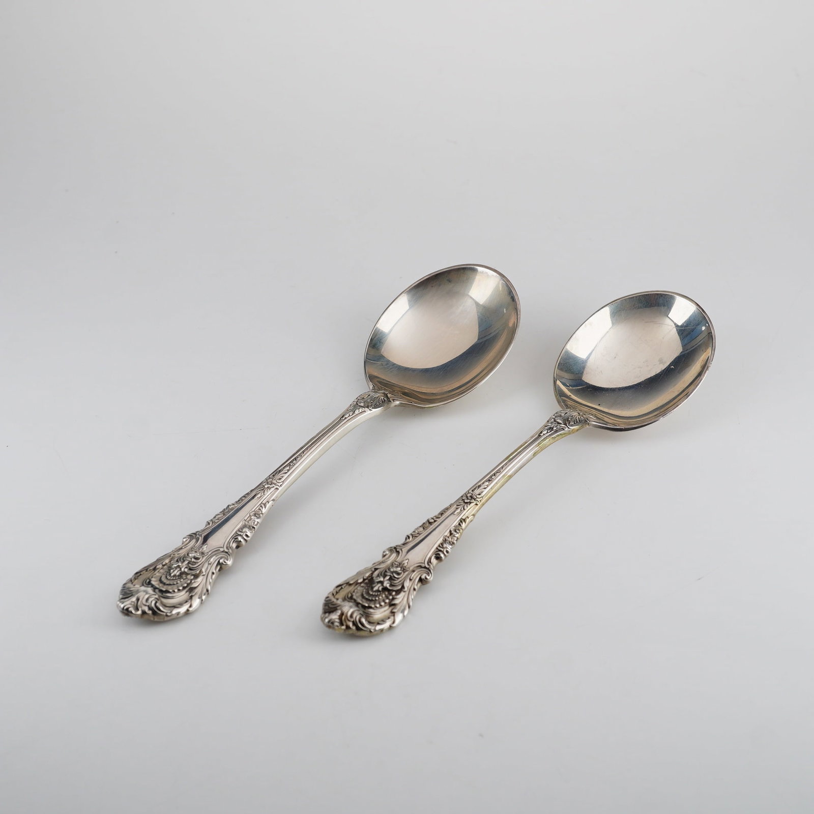 Pair of Wallace Sterling Silver Soup Spoons, Sir Christopher Pattern: Introduced in 1936 and designed by William S. Warren, this pattern features a highly ornate Baroque revival style with deep-relief sculptural motifs including shells, scrolls, acanthus leaves, and fru