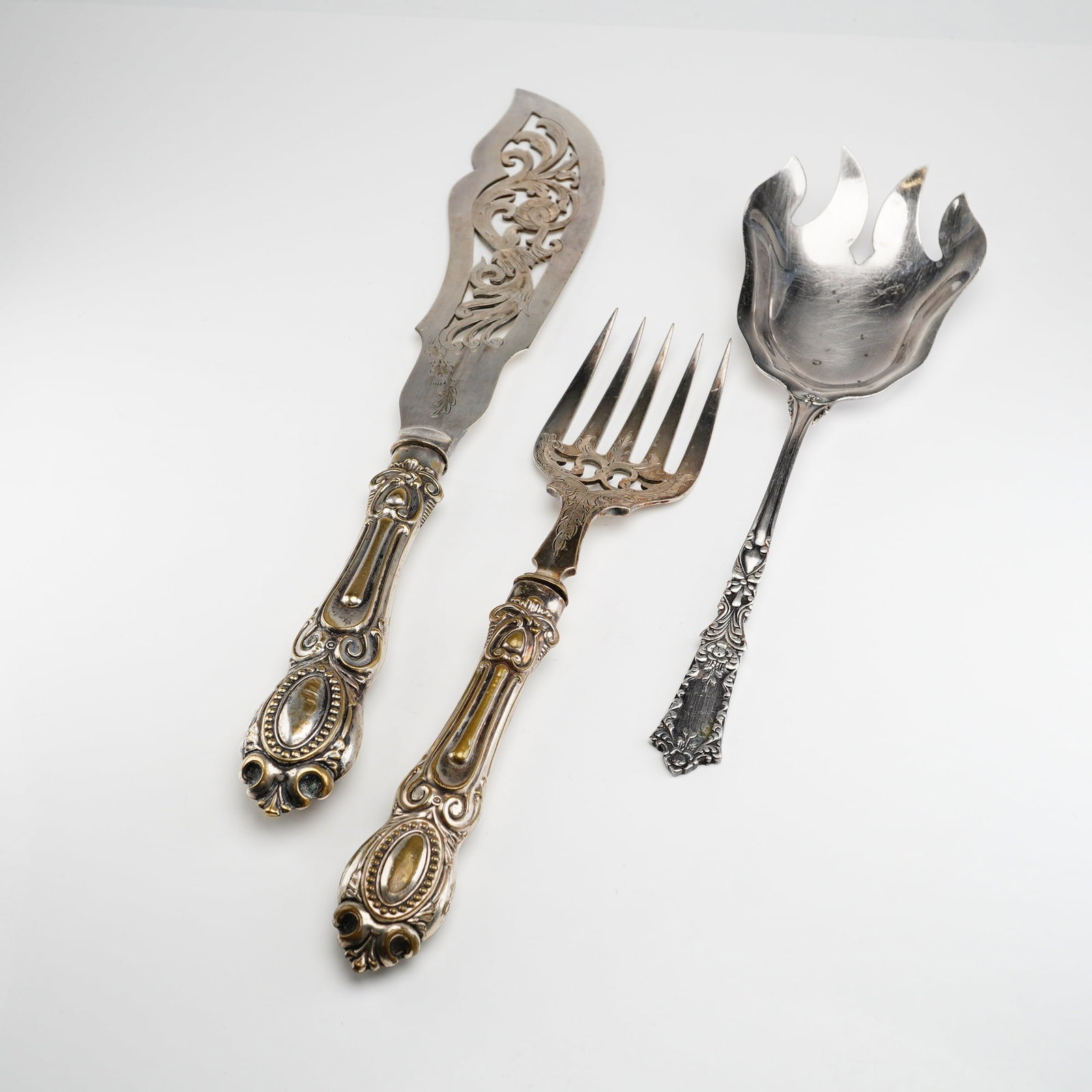 3pc R. Blackinton & Co. and William Hutton & Sons Silver-Plated Serving Utensils: This lot includes one silver-plated salad fork by R. Blackinton & Co., and a matched silver-plated cold meat serving fork and knife set by William Hutton & Sons. Each piece features handles decorated 