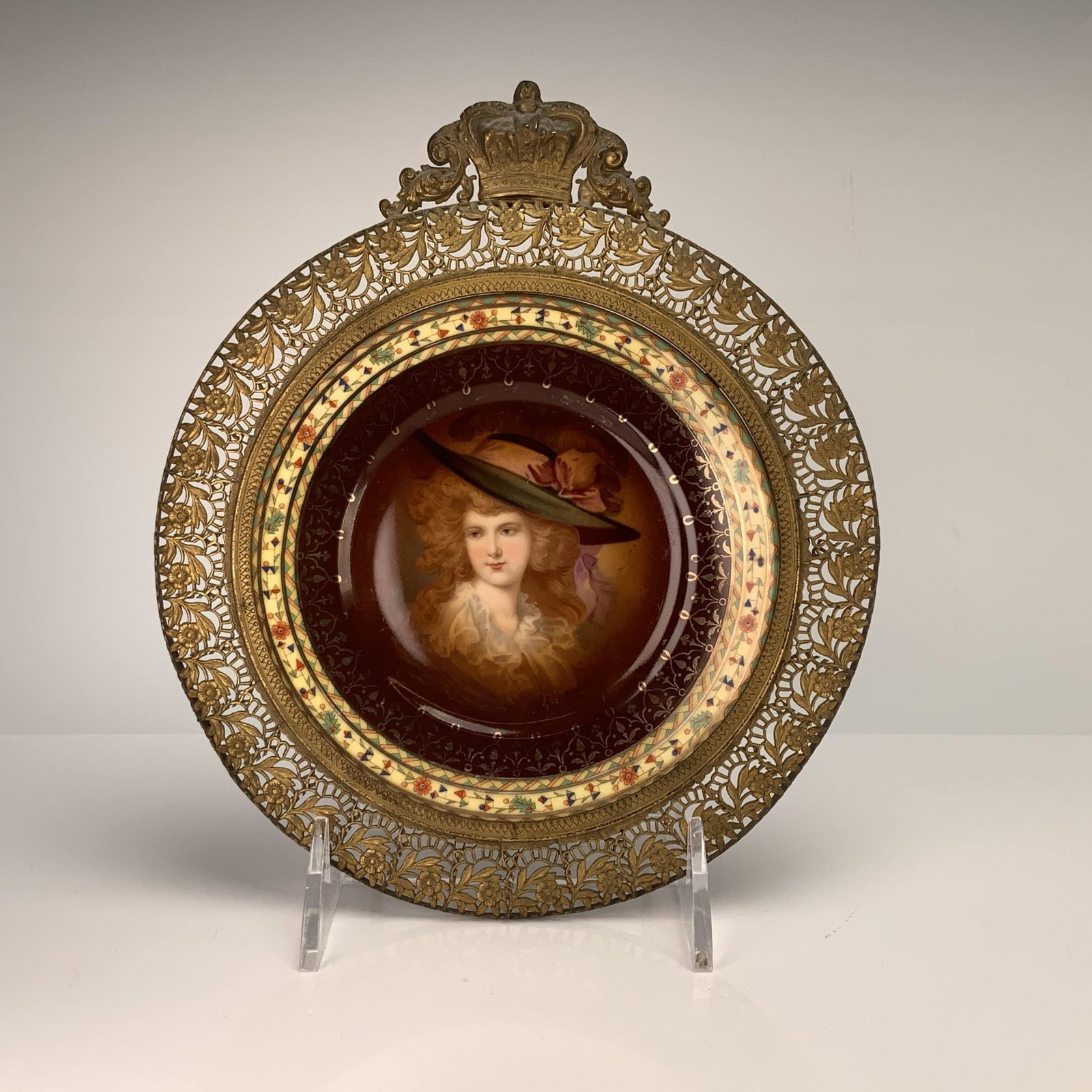 Lady Amorosa Hand Decorated Porcelain Portrait Plate in Ornate French Filigree Frame: A Royal Vienna style porcelain portrait plate featuring the subject Lady Amorosa. This hand decorated portrait plate is set within an ornate French metal filigree frame. The central hand-painted portr