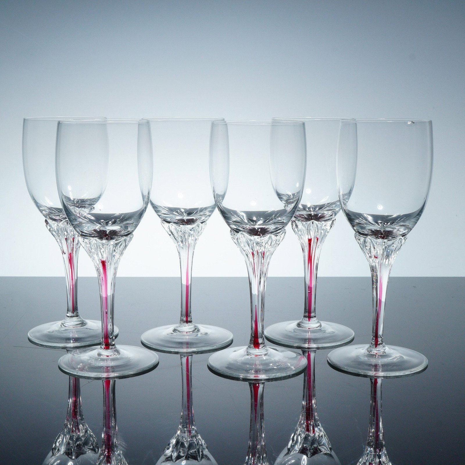 6pc American Cut Cordial Glasses, AMC2: Six cordial glassed distinguished by elegantly sculpted red striped stems. Each glass features a finely rounded bowl and a faceted transition between bowl and stem. Dimensions: 2.25"W x 5.5"H Manufact