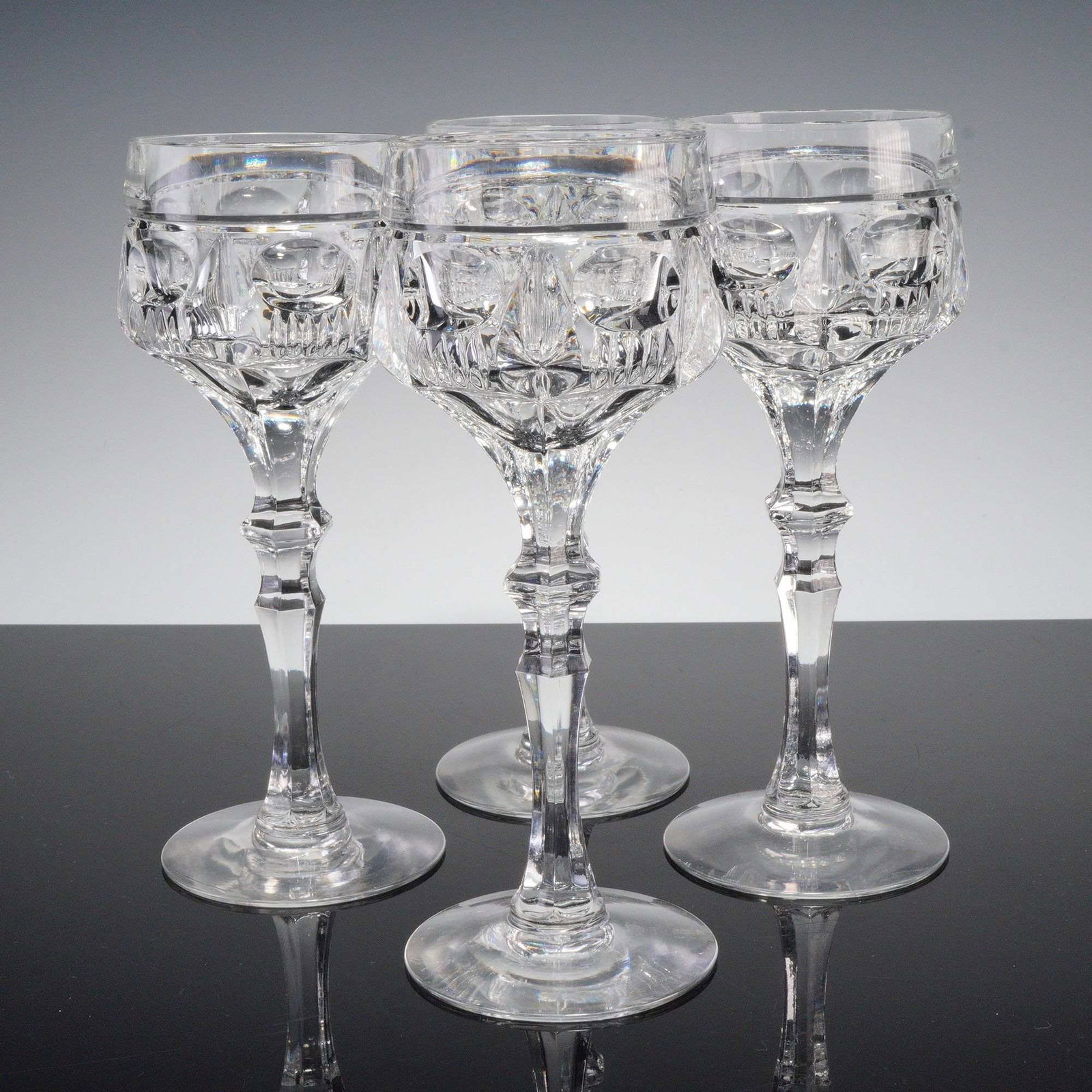 4pc Clear Cut Crystal Tall Cocktail Glasses: Set of four clear cut crystal specialty cocktail glasses featuring faceted stems and geometric banding with intricate prism detail. Finely crafted with excellent clarity, perfect for serving wine or c
