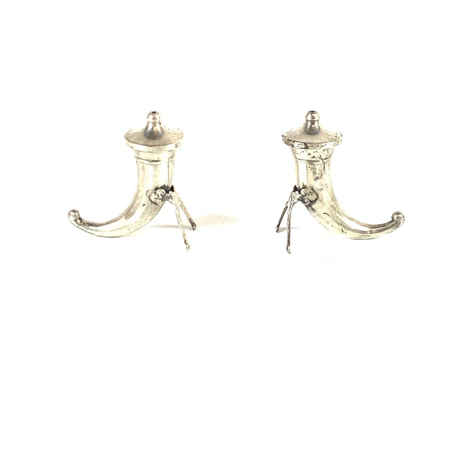 Pair of Swedish Sterling Silver Viking Horn Salt and Pepper Shakers: This pair of sterling silver salt and pepper shakers is designed in the form of traditional Viking drinking horns. Each shaker features a curved, tapered body with a flared rim and a removable, pierce
