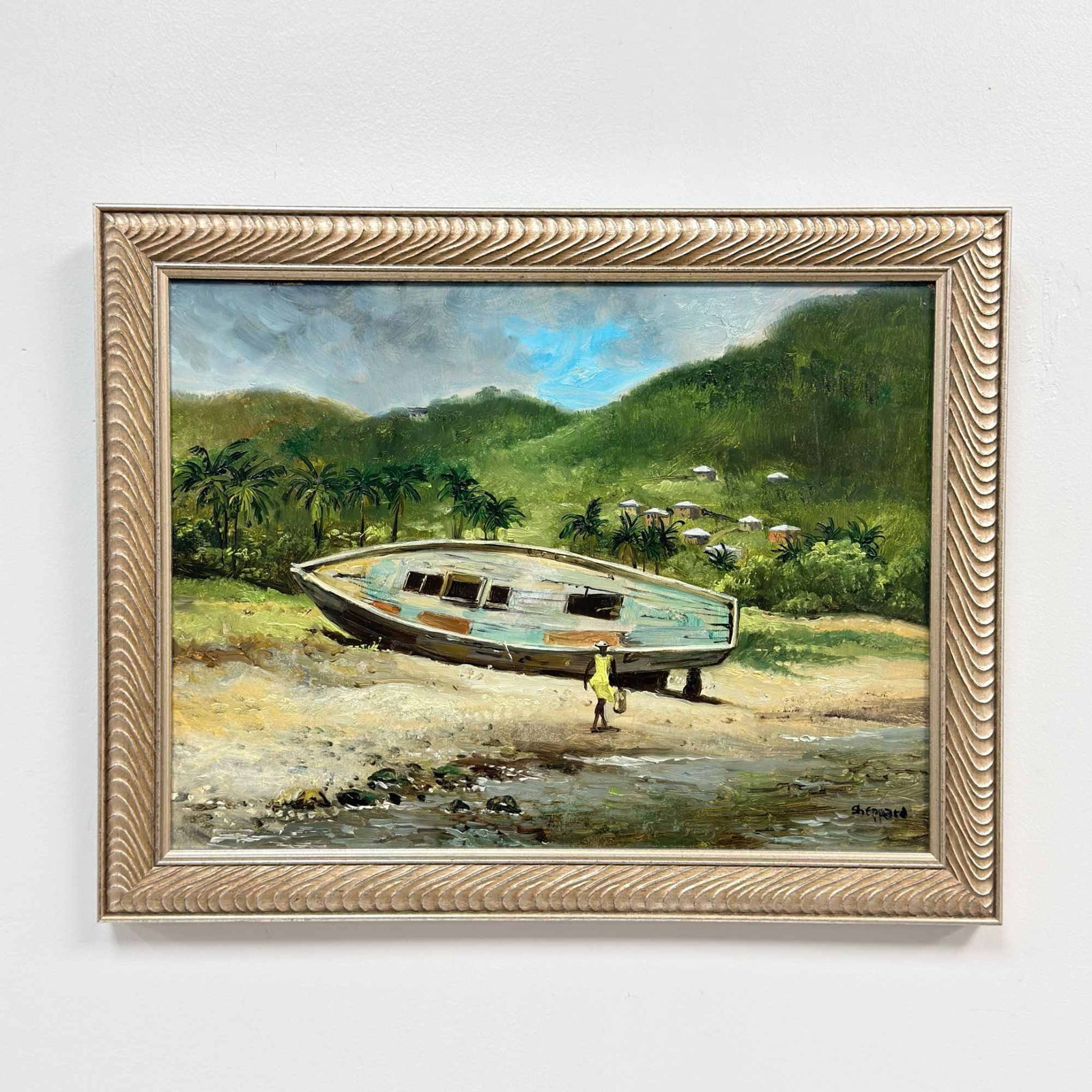 Joseph Sherly Sheppard (American, b. 1930) Oil on Board, Tropical Coastal Scene with Beached Boat: This oil on board depicts a vibrant tropical coastal scene centered on a large beached wooden boat with a white and pale blue hull. A single figure wearing a bright yellow dress and hat is positioned 