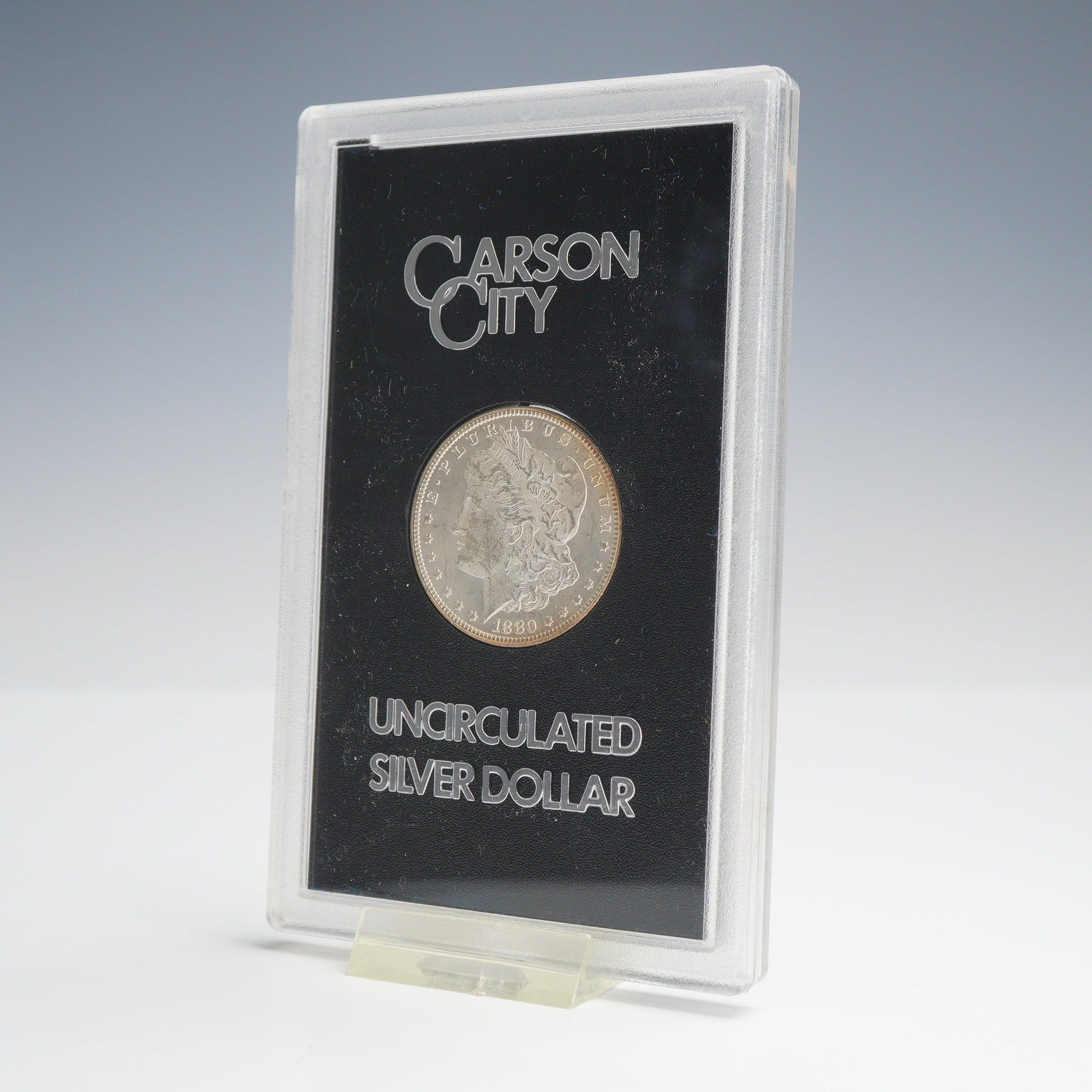 US 1880-CC Carson City Mint Morgan Silver Dollar: This US 1880-CC Morgan silver dollar was struck at the Carson City Mint and is part of the General Services Administration (GSA) government hoard. The coin features the Morgan obverse and reverse desi