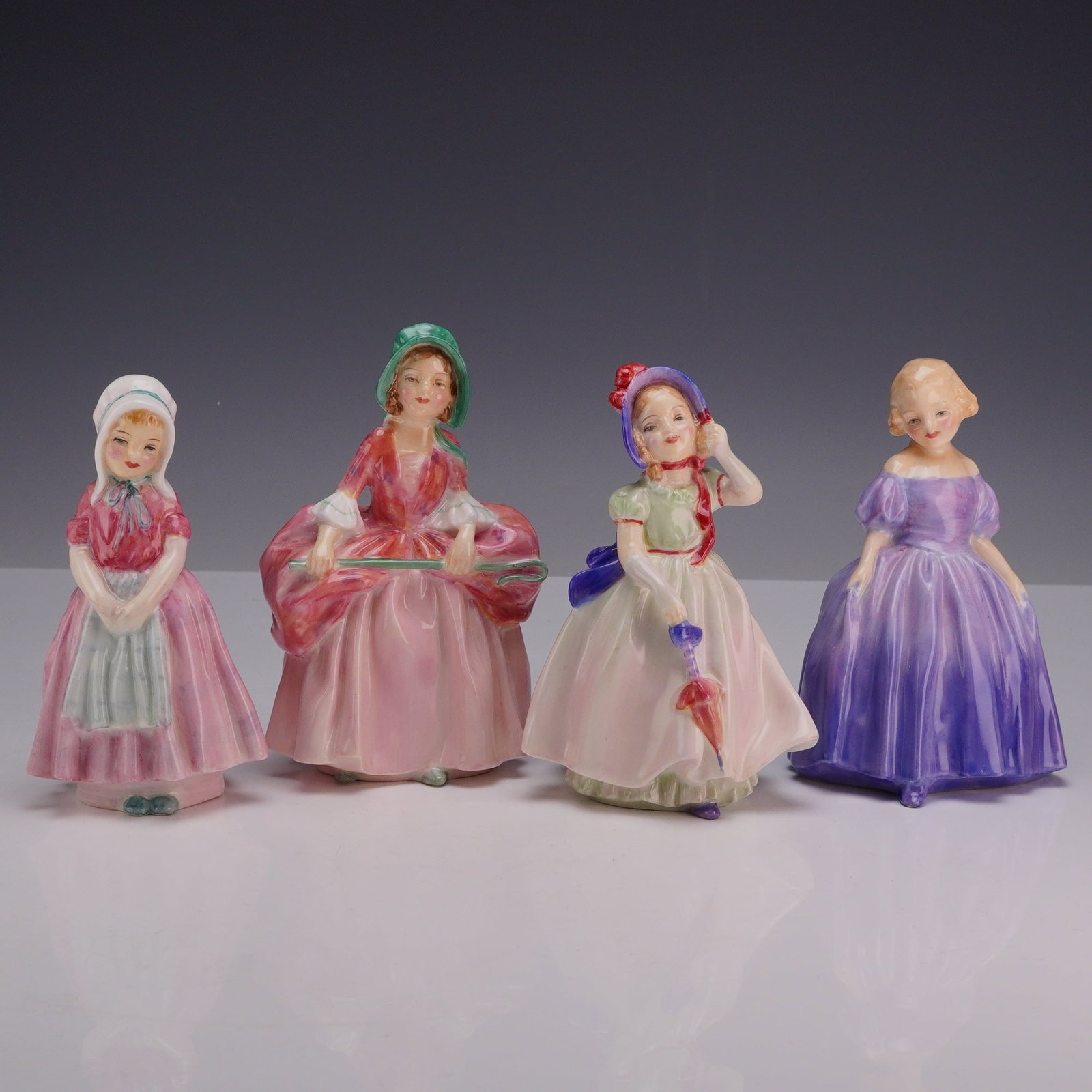 4pc Royal Doulton Bone China Figurines, Tootles, Bo Peep, Babie, and Marie.: Collection of four Royal Doulton figures, each designed by Leslie Harradine. "Tootles" HN1680 depicts a young girl dressed in a pink gown with a pale blue apron and white bonnet. "Bo Peep" HN1811 port