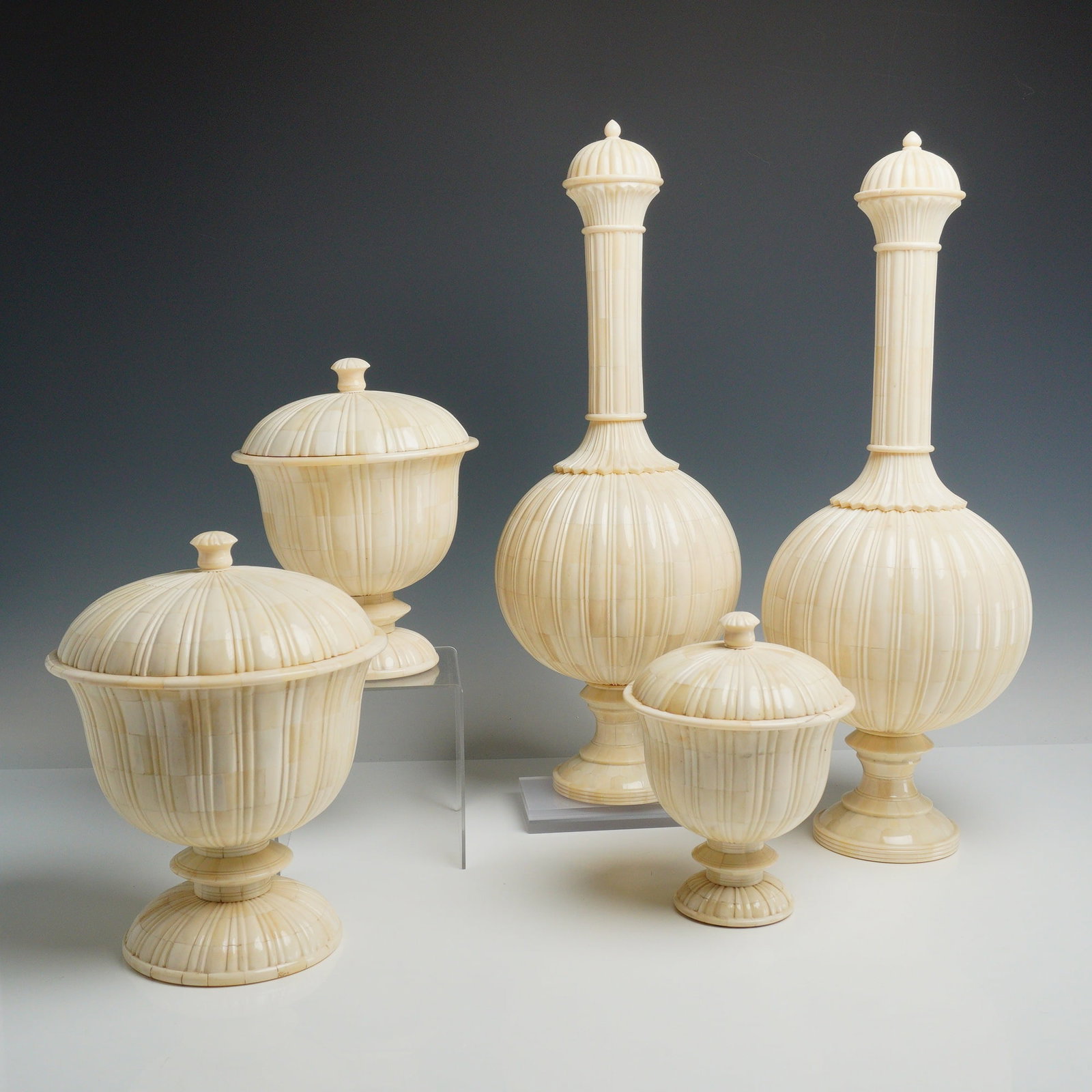 5pc Tozai Home Bone Clad Decorative Table Jar and Bottle Set: A five-piece set of decorative table vessels manufactured by Tozai Home in Italy. This grouping consists of three lidded urns of varying sizes and two tall, narrow-necked bottles with lids. Each piece
