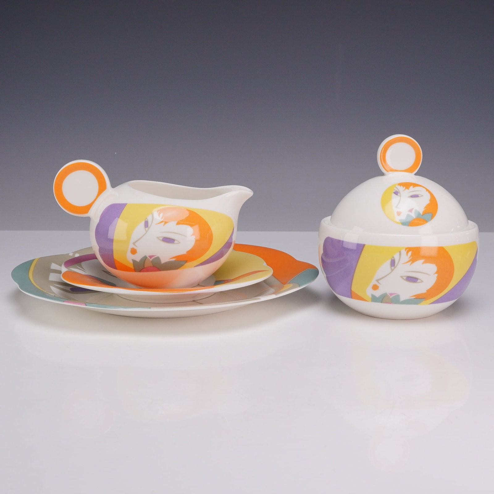 4-Piece Sango Larry Laslo Tableware- Plates, Sugar Bowl and Creamer, Visage: This four-piece Sango ceramic collection from the Visage pattern was designed by Larry Laslo and manufactured in 1986. The lot includes a creamer, a sugar bowl with its corresponding lid, and two plat