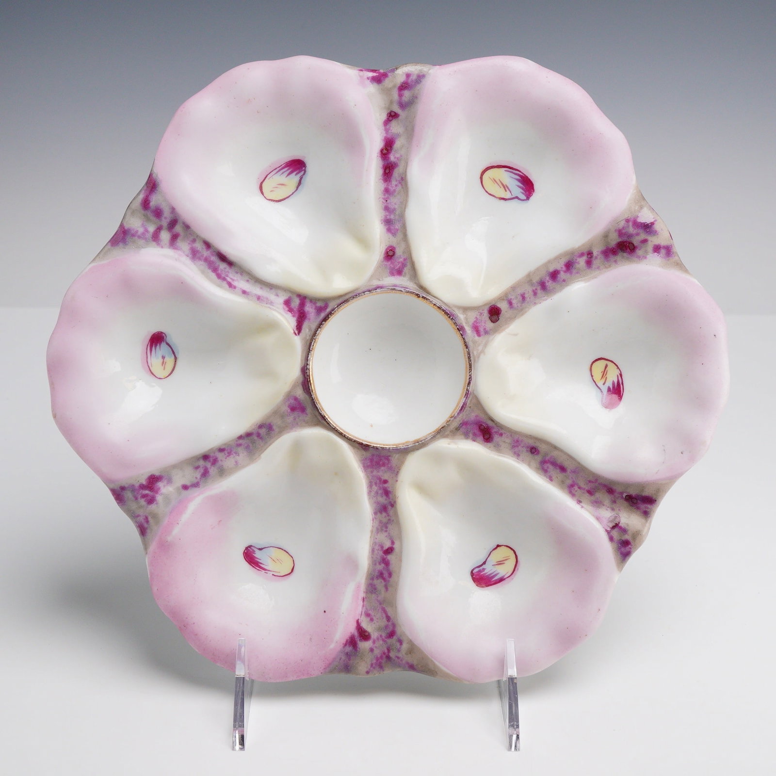 Oyster Plate Shell Pattern Plate OYP43: This Oyster Plate OYP43 features six relief-molded shell wells arranged around a central circular sauce well. The piece displays shell wells finished in a lustrous white glaze with hand-painted pale
