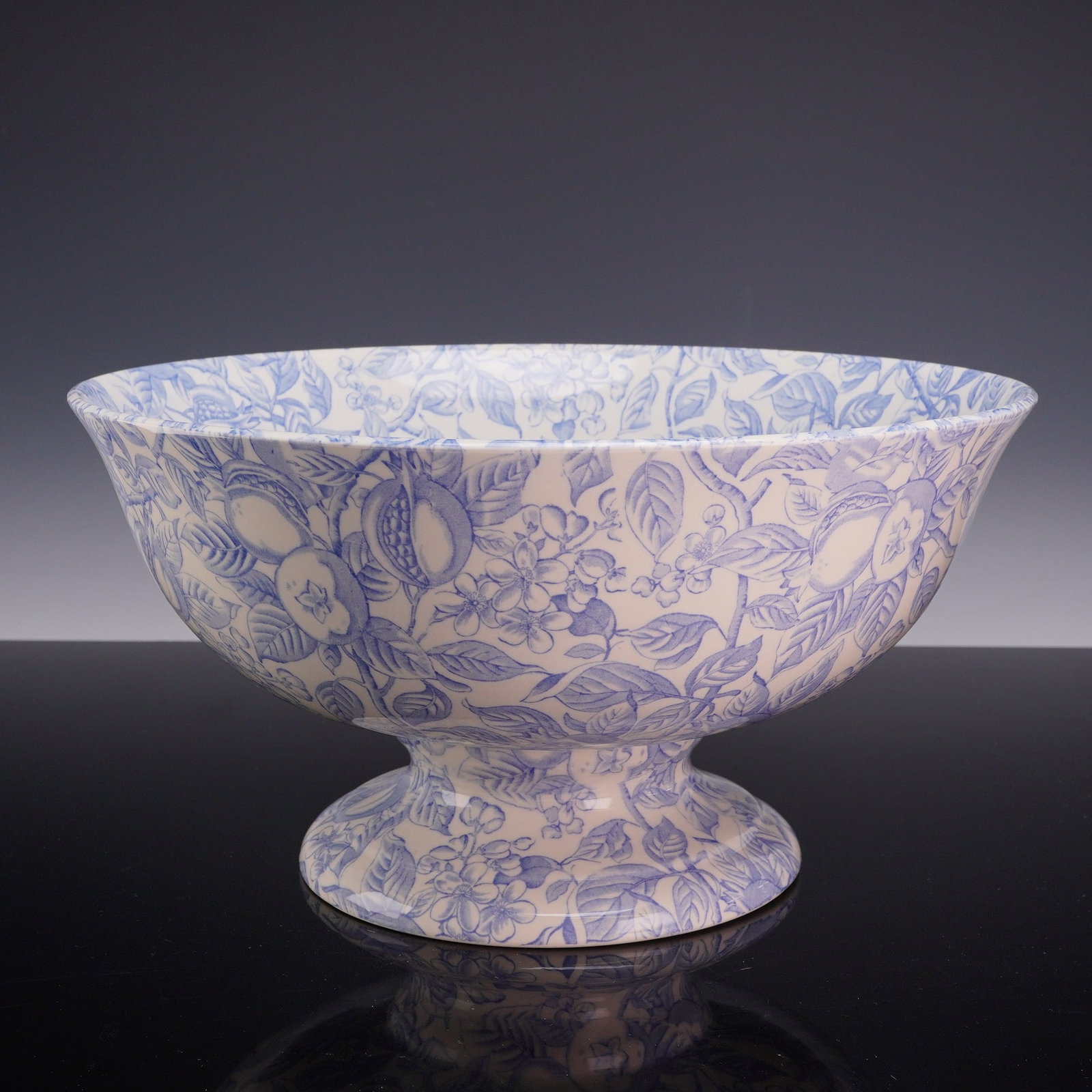 Burleigh Pomegranate Pattern Footed Center Bowl: A large earthenware footed center bowl or comport manufactured by Burgess, Dorling & Leigh Ltd. (Burleigh) of Burslem, England. The vessel features a wide, circular bowl with a flaring rim, supported 