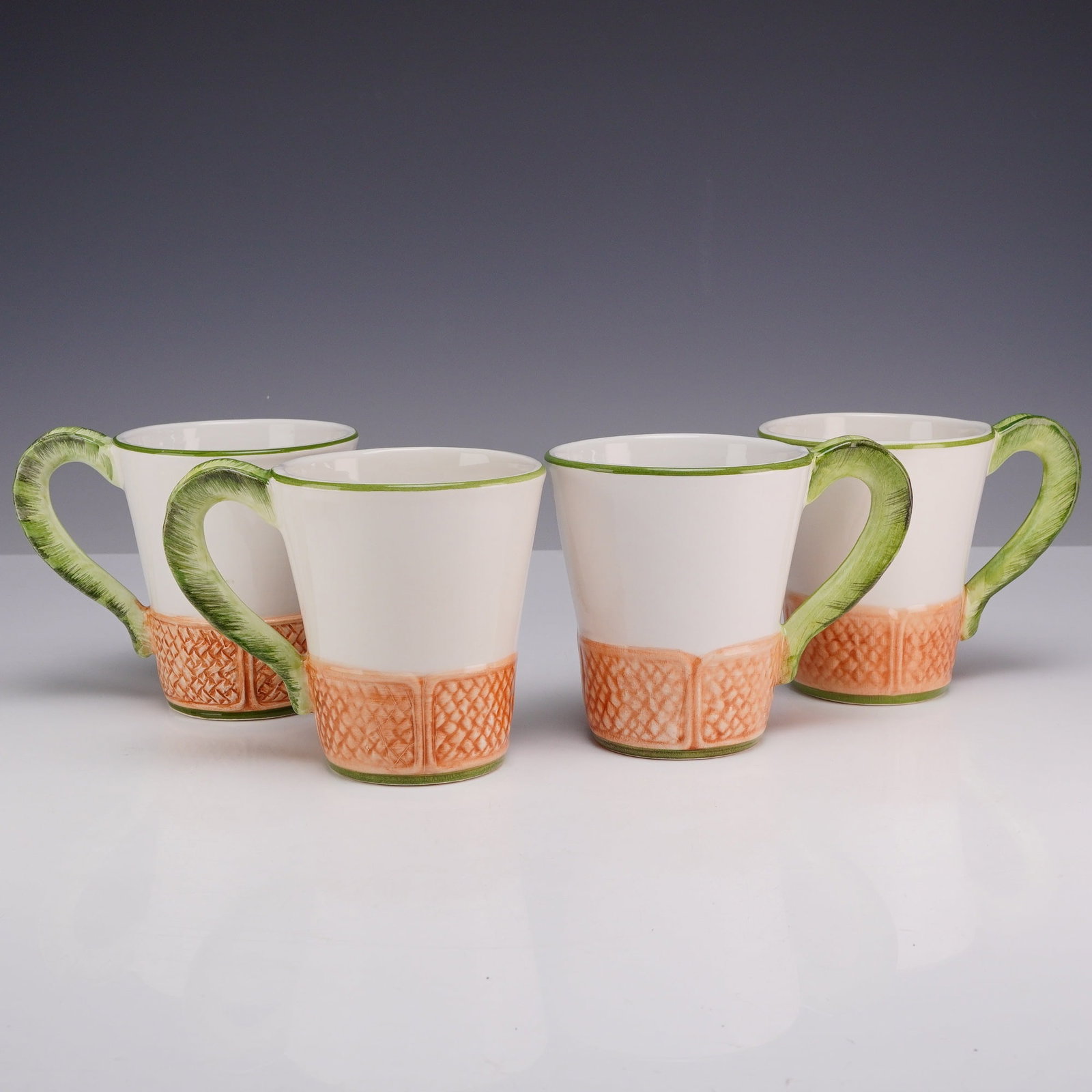 4pc Vietri Italian Mugs, Oasi: A set of four contemporary earthenware mugs, made in Italy for the American importer Vietri. Each mug features a tapered form that flares toward the rim, complemented by a coral-scale texture around t