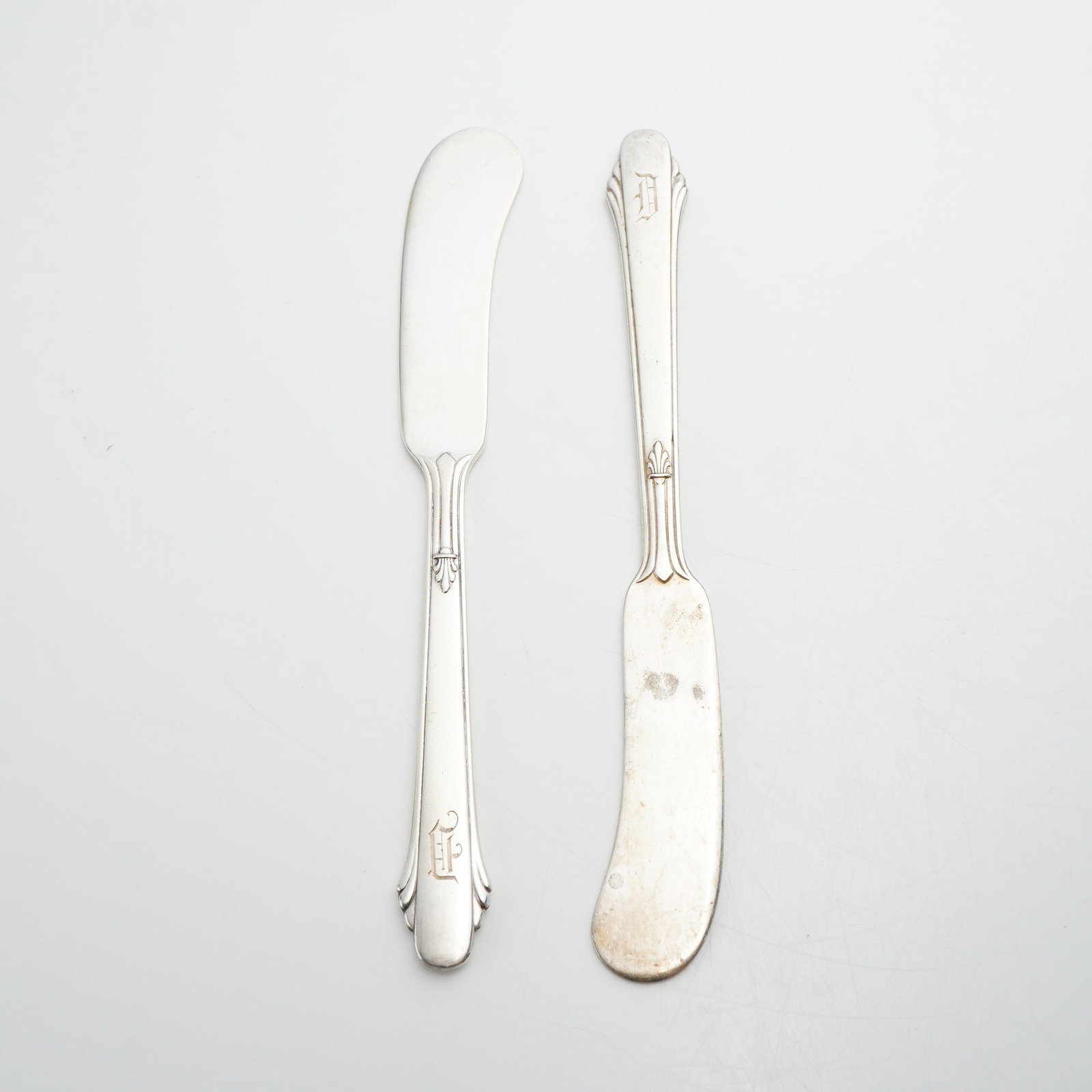 Pair of Gorham Sterling Silver Flat Handle Butter Spreader Knives: This lot consists of two small sterling silver flat handle butter spreader knives produced by the Gorham Manufacturing Company. Originally introduced in 1910, the pattern is characterized by an