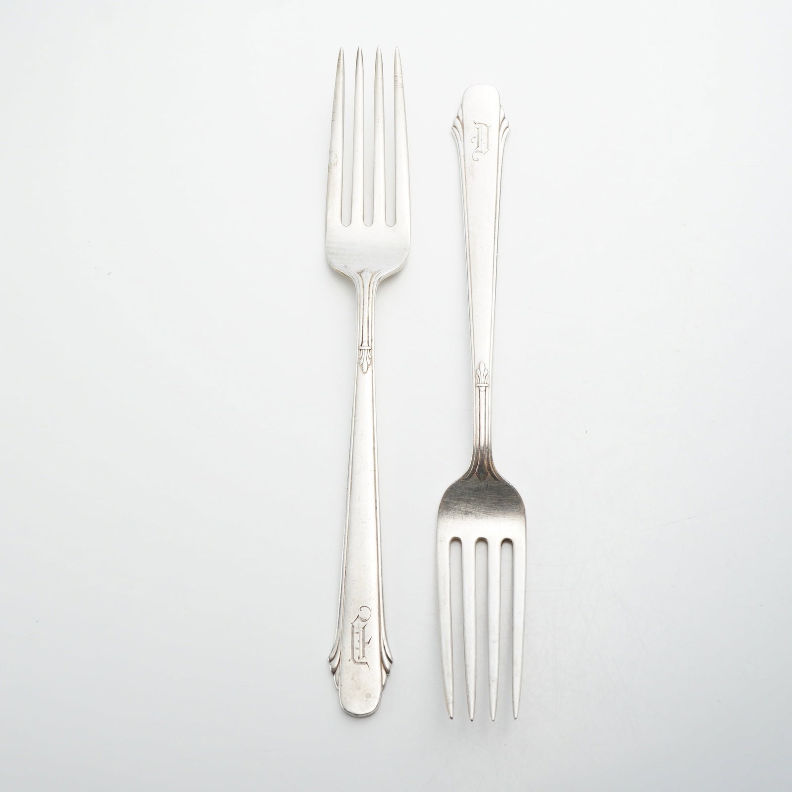 Pair of Gorham Sterling Silver Forks, Hunt Club Pattern: A pair of solid sterling silver forks in the Hunt Club pattern by the Gorham Manufacturing Company. The design is characteristic of the Art Deco period, featuring a flared, angular handle terminal