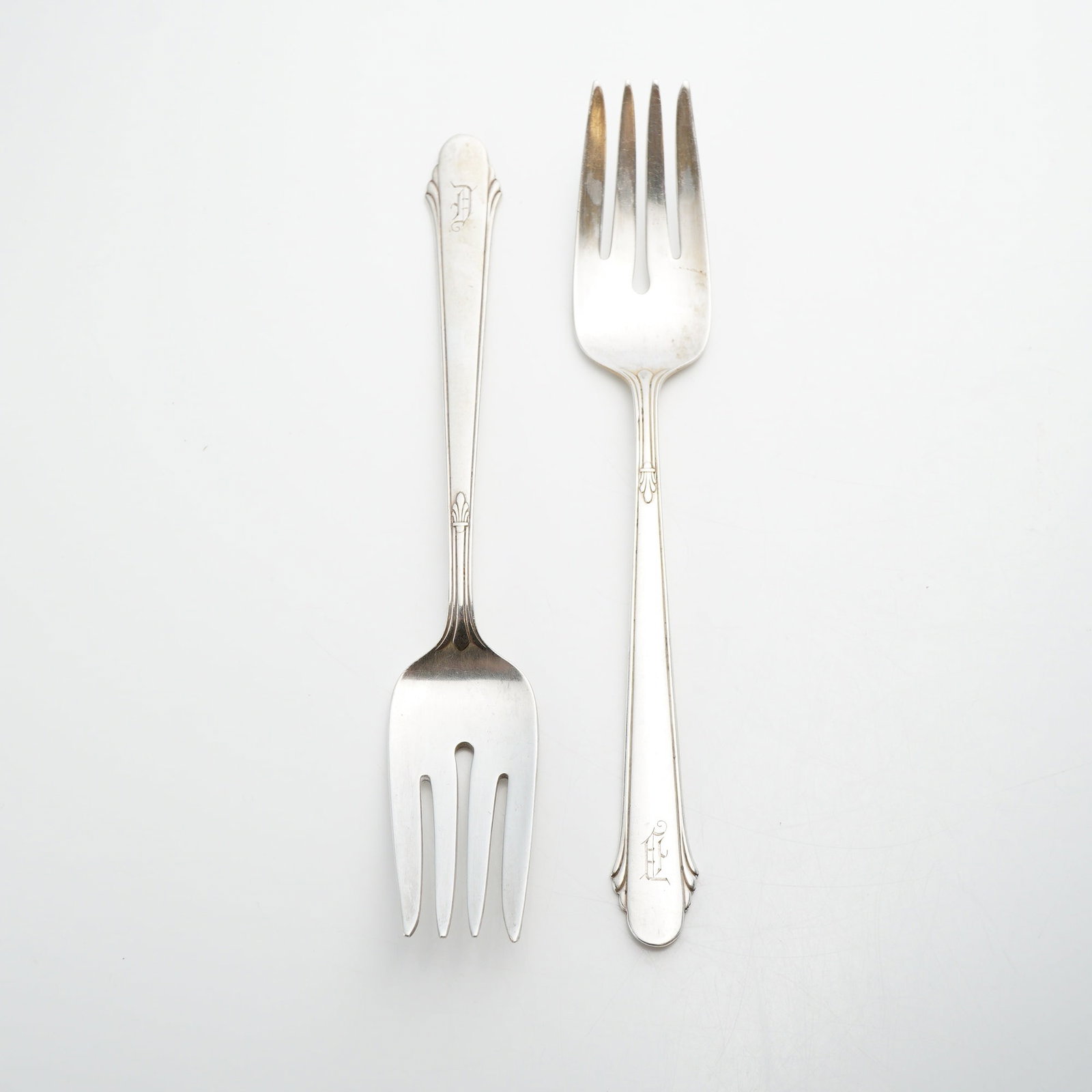 Pair of Gorham Sterling Silver Forks, Hunt Club Pattern: This lot consists of two sterling silver forks in the Hunt Club pattern by the Gorham Manufacturing Company. Introduced in 1930, the pattern features minimalist Art Deco lines and a stylized shell