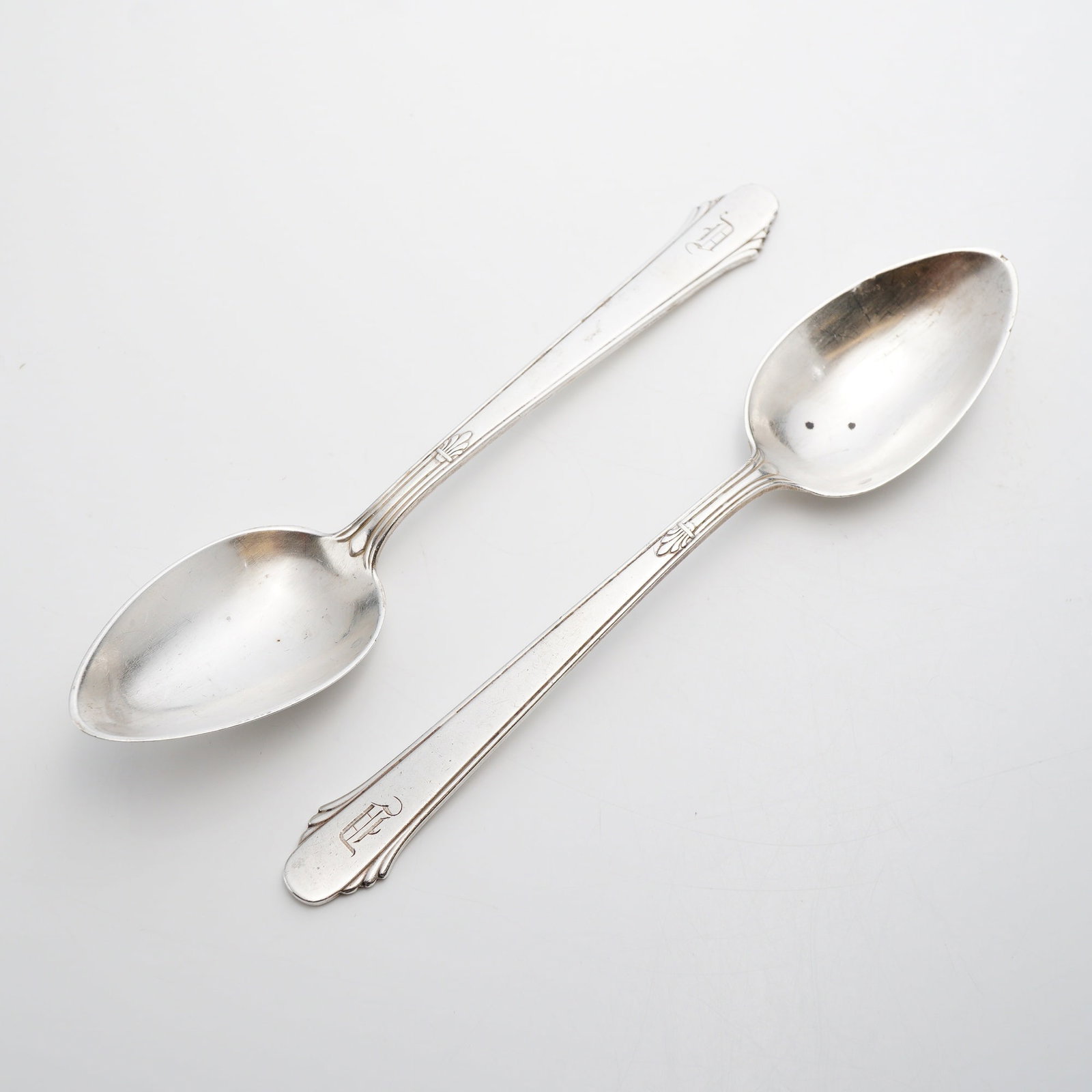 Pair of Gorham Sterling Silver Spoons, Hunt Club Pattern: This lot of 2 sterling silver Gorham spoons is in the Hunt Club pattern, which was designed by Gilbert Crowell and patented in 1915. The spoons are crafted from solid sterling silver and feature a