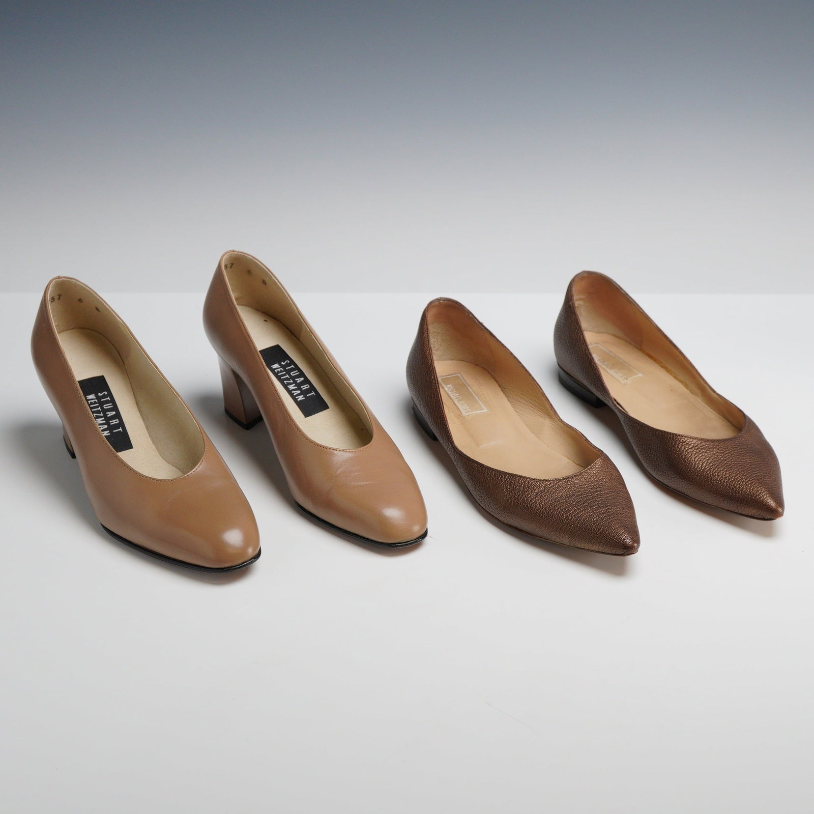 A Pair of Stuart Weitzman Leather Pumps and Michael Kors Metallic Flats: This lot features two pairs of designer women’s footwear. The first is a pair of Stuart Weitzman classic round-toe pumps in tan smooth leather, featuring a sturdy block heel measuring approximately