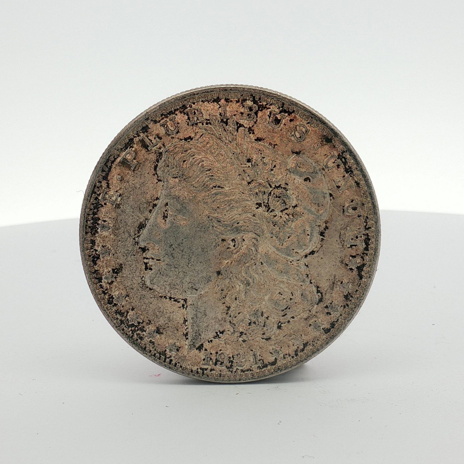 1921 US Morgan Silver Dollar Coin Circulated: This 1921 US Morgan dollar is a silver coin struck at the Philadelphia Mint. It is composed of 90 percent silver and 10 percent copper. The coin features the Morgan dollar Liberty Head facing left on 