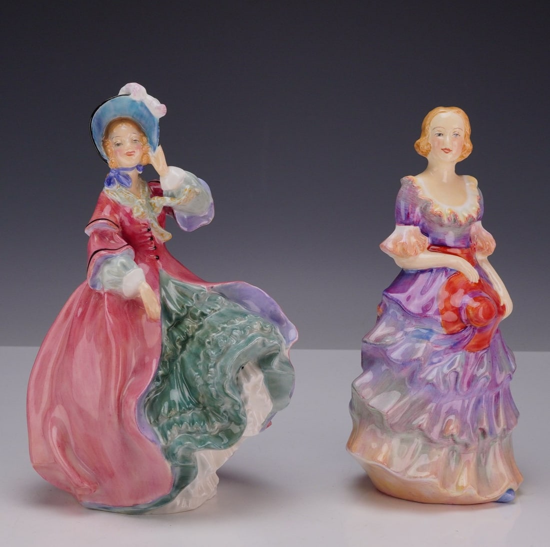 2pc Royal Doulton and Paragon Bone China Figurines, Spring Morning HN1922 and Valerie: This collection features two elegant porcelain figures. Included is a Royal Doulton figure, “Spring Morning,” designed by Leslie Harradine, depicting a woman posed in the breeze wearing a flow