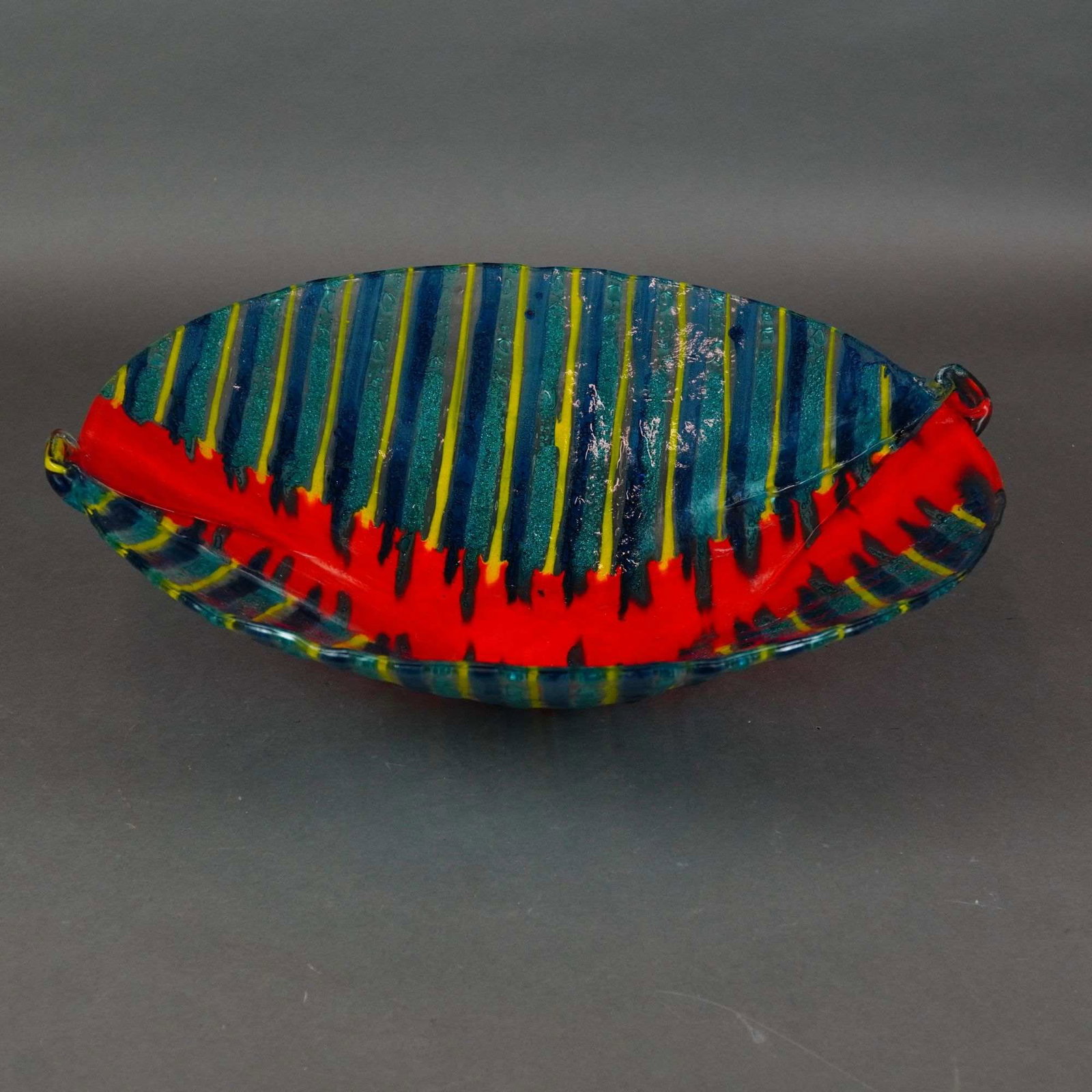 Kaleidoscopio Fused Art Glass Bowl, Made in Italy: A handmade art glass bowl by Kaleidoscopio, made in Italy. This shallow, elongated vessel features a boat-shaped form with ends pinched upward to create small, integrated handles. The piece is constru