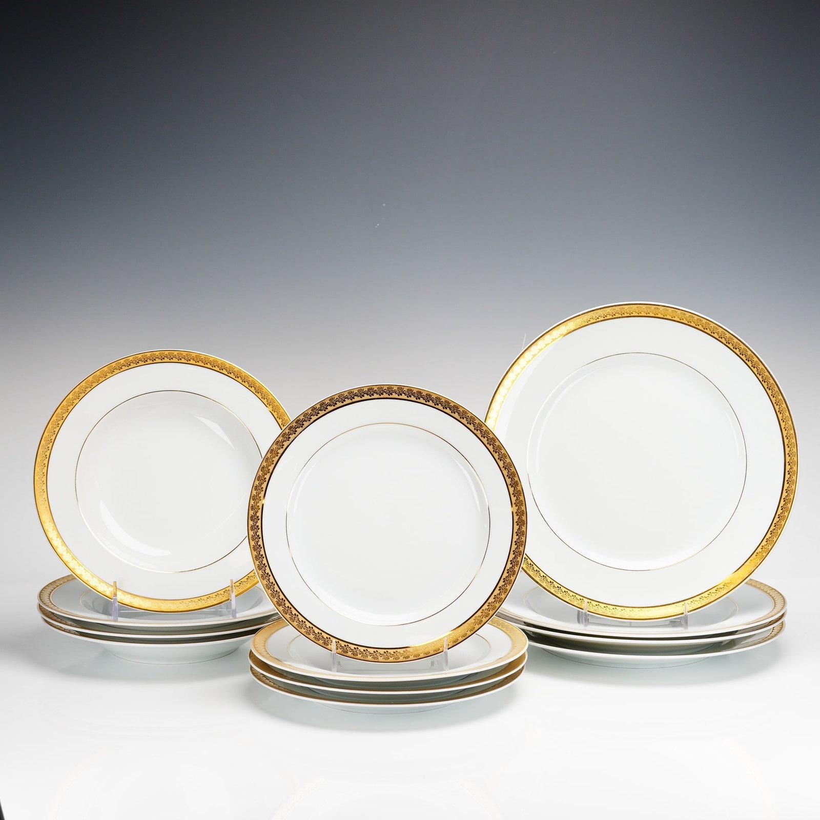 12pc Bernardaud Limoges France Porcelain Plates and Bowls Set, Rhapsody Pattern: Each piece features a white ground with a wide, acid-etched style gold filigree border on the rim and a secondary thin gold pinstripe. The rims are finished with a gilded edge. The collection consists