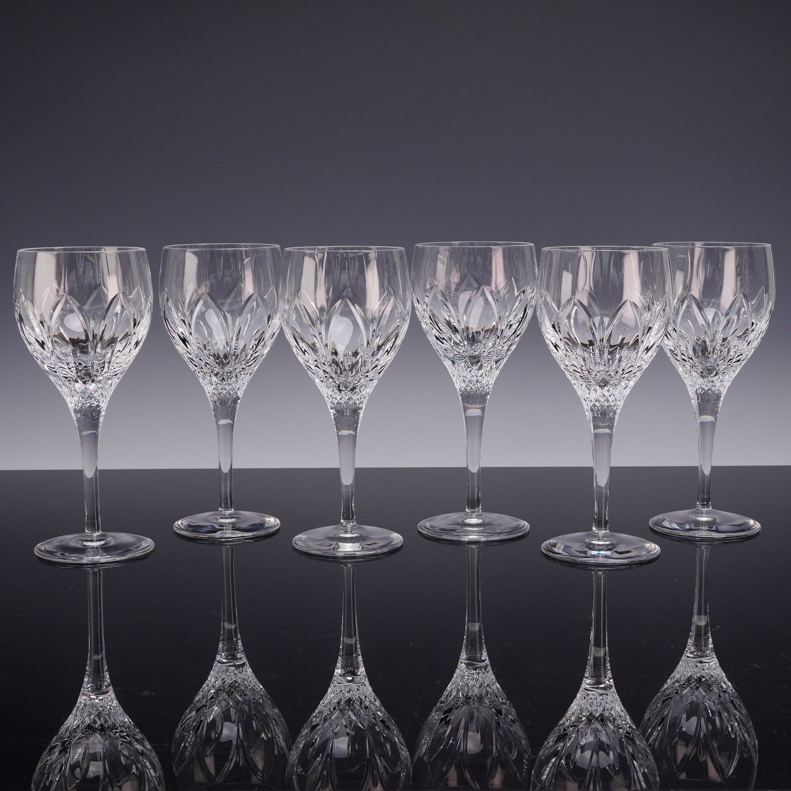 6pc Atlantis Crystal Chartres Small Wine Glass Goblets: This set of six crystal goblets is produced by Atlantis in the Chartres cut pattern. Each piece is crafted from lead crystal, featuring a complex cut design that provides high light refraction. The bo