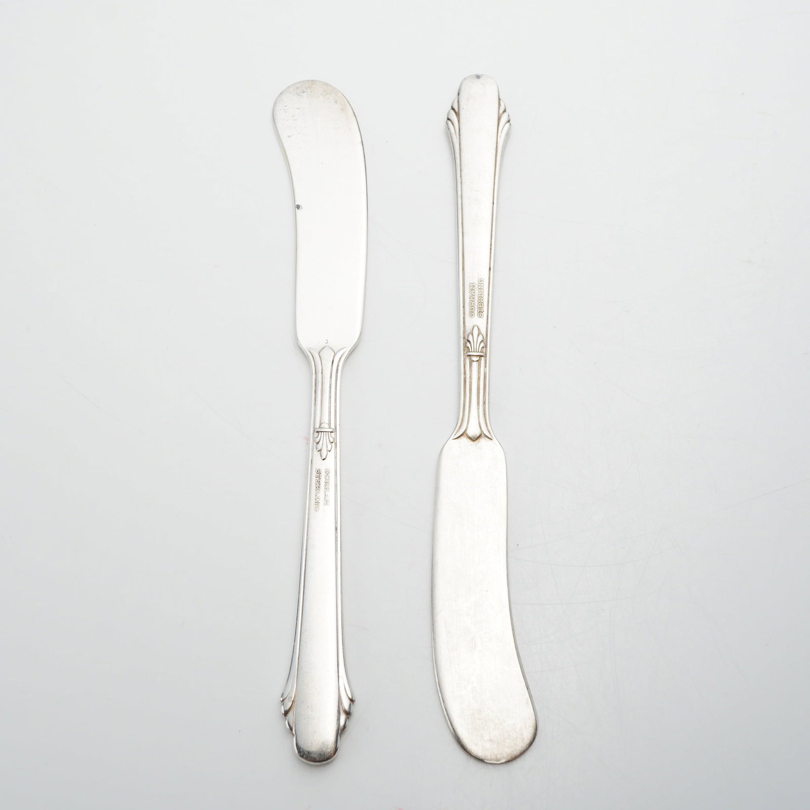 Pair of Gorham Sterling Silver Flat Handle Butter Spreader Knives: This lot of 2 small butter spreader knives is made of solid sterling silver and features the Hunt Club pattern by the Gorham Manufacturing Company. The Hunt Club design is characterized by its Art Dec