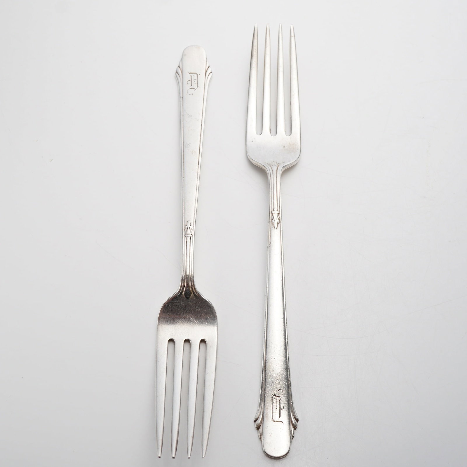 Pair of Gorham Sterling Silver Forks, Hunt Club Pattern: This lot of 2 sterling silver Gorham forks includes one dinner fork and one smaller luncheon or salad fork. The items are rendered in the Hunt Club pattern, featuring an Art Deco design with a tapered