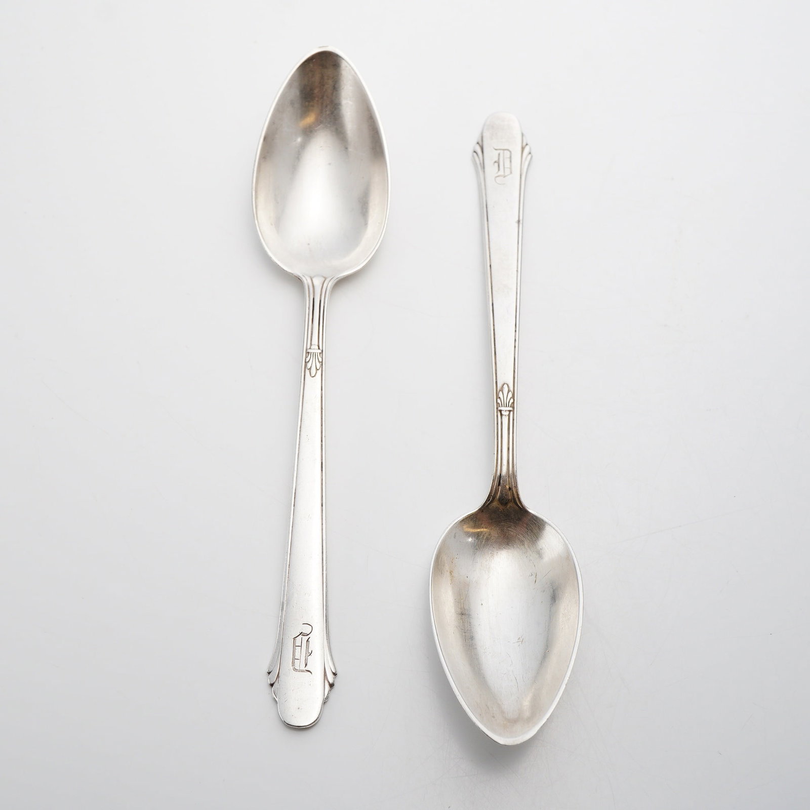 Pair of Gorham Sterling Silver Spoons, Hunt Club Pattern: This lot of 2 sterling silver Gorham spoons is designed in the Hunt Club pattern, which was patented in 1930. These pieces are representative of the Art Deco style, featuring a stylized fan or shell m