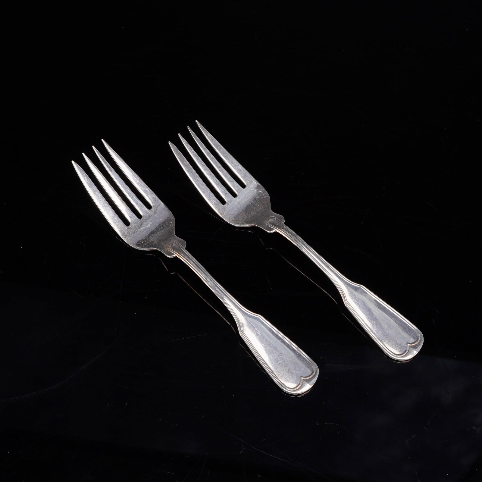 A Pair of Frank W. Smith Silver Co. Sterling Silver Forks in the Fiddle Thread Pattern: A pair of sterling silver forks manufactured by Frank W. Smith Silver Co. The design is characterized by handles with double-notched shoulders and a flared, rounded terminal accented by a small scroll