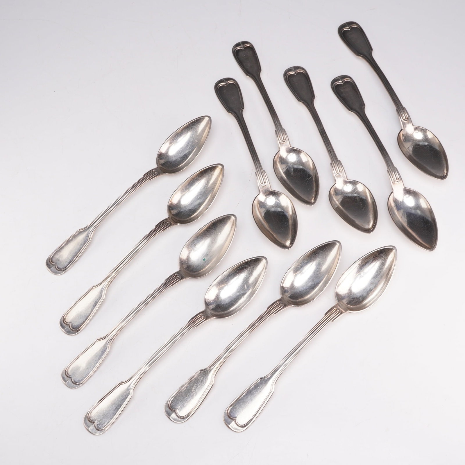 11pc 800 Silver Teaspoons: This set of teaspoons feature a heart-like motif at the handle and are hallmarked 800 on the reverse. Weight: 209 g
